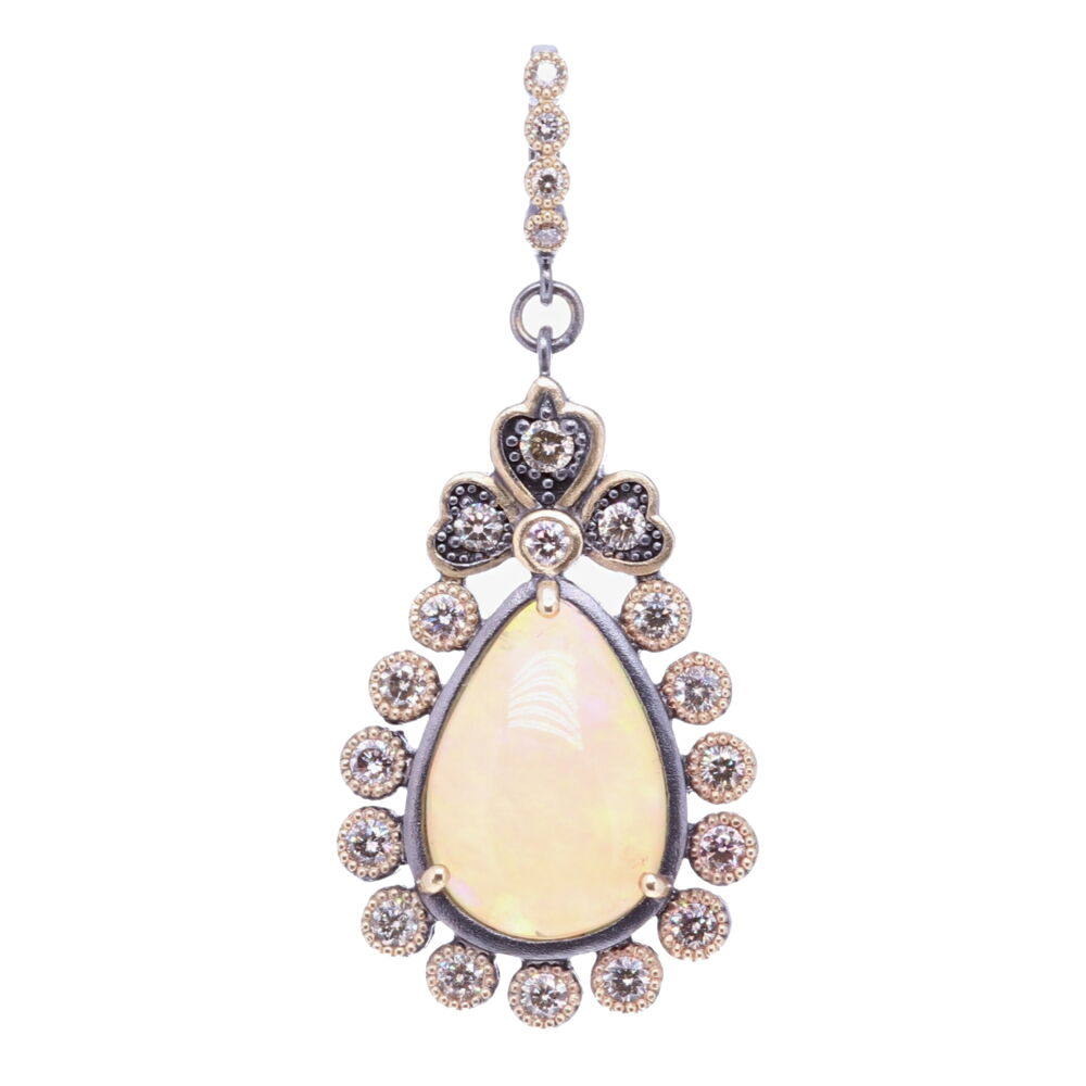 This beautiful pear shaped opal is set in a unique diamond bezel. The diamond weight is 1.1 tcw, 14k yellow gold 5.88g, and rhodium sterling silver. Pear Shaped Opal Pendant