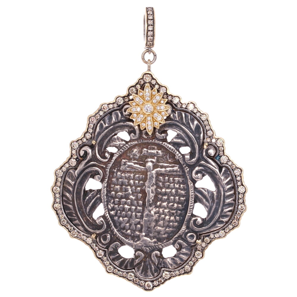 This French Crucifix medal displays Jesus on the back. The original medal was made by a master silversmith and the decorative filigree adds a feminine touch to the piece. Wearing a crucifix, shows your commitment to the Christian faith and provides protection from evil. The practice of wearing a cross displays victory of Jesus over sin and death. This pendant is set in a Cynthia Ann 14k Yellow Gold 4.46g, Diamond 1.75 tcw, and rhodium sterling bezel. French Crucifix Medal Pendant