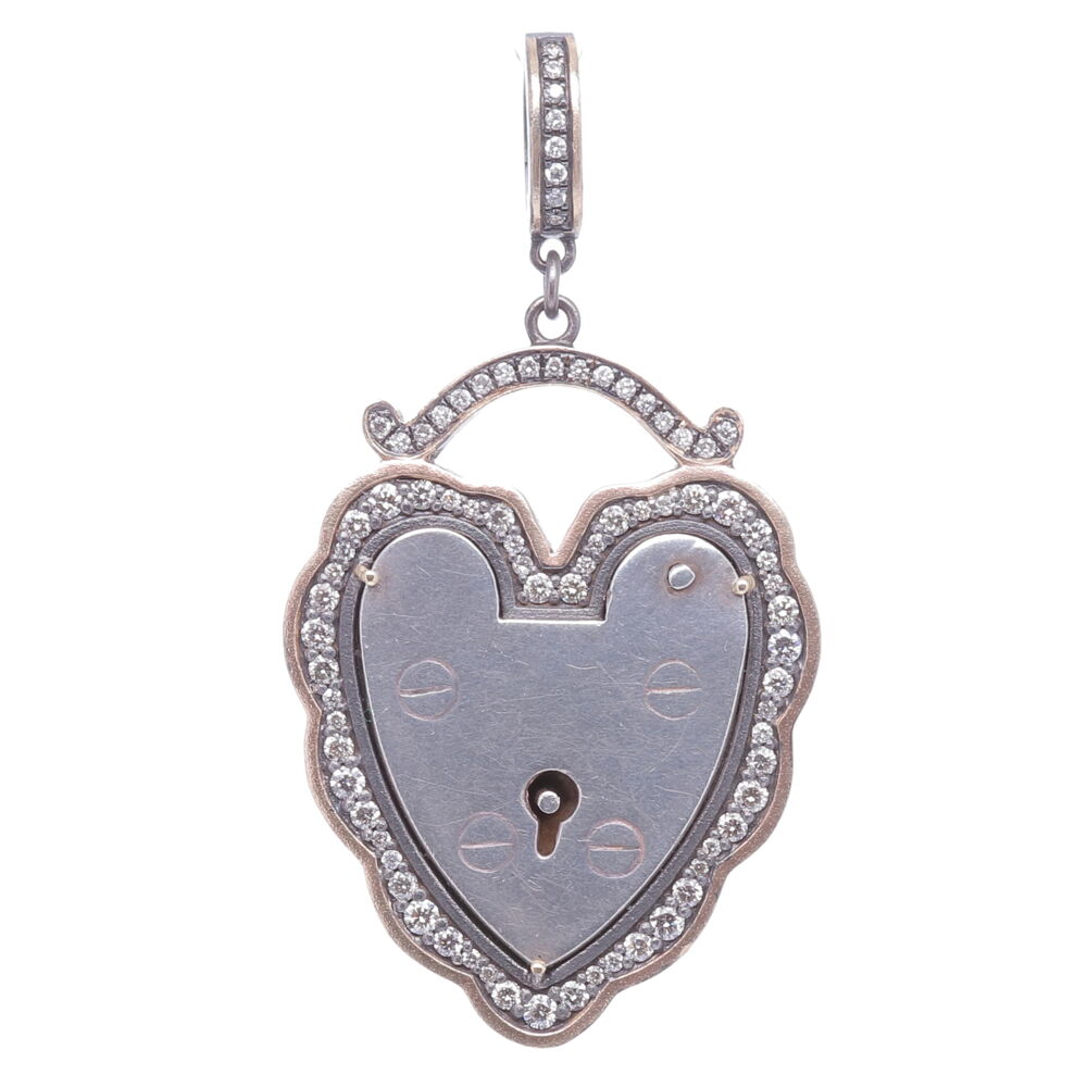 The Antique English padlock was typically worn on a bracelet and given to a loved one to show how much they were loved. Before going off to war, gentlemen would leave the bracelet locked around his loved one’s wrist and he would hold the key until his return. Heart shaped padlocks were fashionable in the Victorian and Edwardian periods. This original antique padlock is set in a Cynthia Ann diamond bezel.
Large Vintage Padlock, Surrounded by a Champagne Diamond, 14k Yellow Gold and Black Rhodium Scalloped Bezel, Hanging from a Champagne Diamond, 14k Gold and Black Rhodium Openable Bale.
Champagne Diamond - 0.80cts
14k Gold - 7.37g Old English Padlock Pendant
