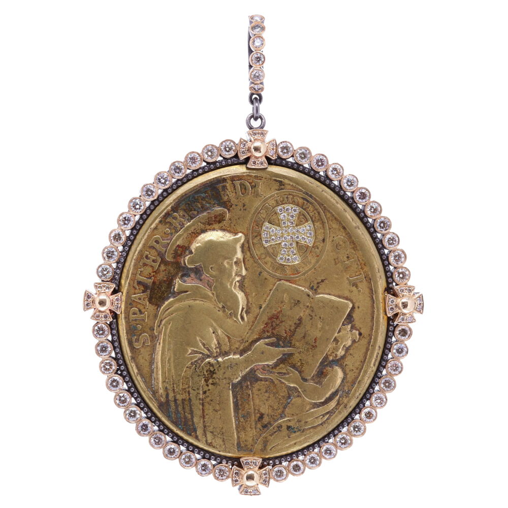 There is indeed no medal which possess such a wonderful power and protection from evil. On the front of this medal it translates to "Father Benedict". The cross is the sign of our redemption, the protection shield given to us by God to ward off evil spirit. At the top of the cross usually stands the word PAX (peace) of the monogram HIS (Jesus). Vertically & Horizontally the letters CSSML & NDSMD mean: May the holy Cross be the light, let not the dragon be the guide. On the back of the bronze medal depicts The lady of Montserrat.
Ancient St. Benedict Medal with a Diamond Cross Inlay set with Champagne Diamonds, 14k Yellow Gold and Black Rhodium Dot Bezel, Hanging From a Champagne Diamond, 14k Yellow Gold and Black Rhodium Openable Bale.
116 Champagne Diamonds - 2.81tcw
14K Yellow Gold - 7.81g
Black Rhodium Silver
Spanish St. Benedict and the Lady of Montserrat