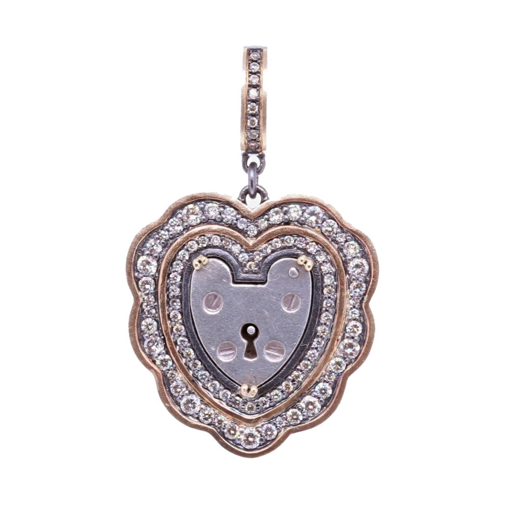 The Antique English padlock was typically worn on a bracelet and given to a loved one to show how much they were loved. Before going off to war, gentlemen would leave the bracelet locked around his loved one’s wrist and he would hold the key until his return. The heart shaped padlock was fashionable in the Victorian and Edwardian periods. This padlock was set inside a Diamond and 14k Yellow Gold bezel. Vintage English Heart Padlock Pendant