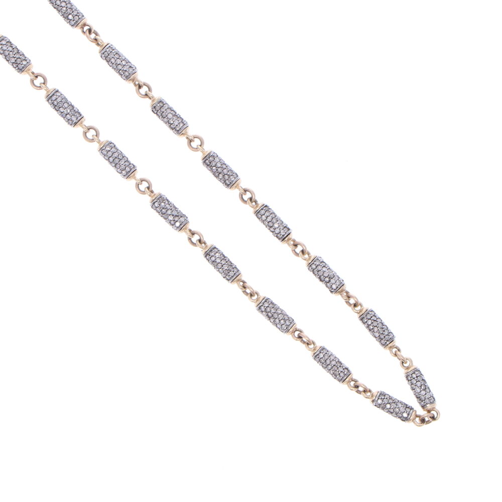 This 24" handcrafted diamond link chain is made of 14k Yellow Gold 5.59g and Rhodium Sterling. The total diamond carat weight is 12.98 tcw. The size of the diamond barrels are 0.57" x 0.14". Large Diamond Barrel Link Chain 24"