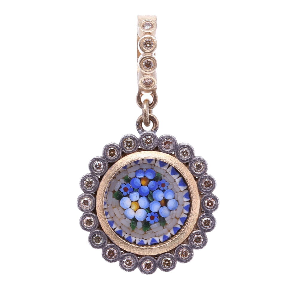 This 19th Century Italian micro mosaic was made by a master craftsman. It's framed by a diamond dot bezel and has a bale with a 4mm opening. There's a piece of clear glass protecting the mosaic. The blue colored mosaic pieces form a series of abstract flowers. Flowers and plants were created by God and they express divine goodness, truth, and beauty. Micromosaics or sometimes referred to as Micro Mosaics are handmade by artisans that use tiny pieces of glass (Tesserae) or enamel like pieces to construct a small figurative image. This mosaic is set in a 14k yellow gold 2.08g, rhodium sterling, and diamond 0.32 tcw bezel. Blue Italian Micro Mosaic Dot Floral Pendant with Glass Cover