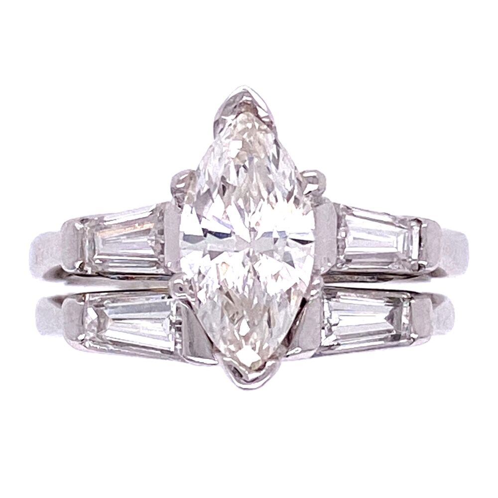 One .89ct beautiful, clean natural marquis cut diamond is the center focus of this ring. It is flanked by two tapered baguette diamonds weighing approximately .20tcw. There is a matching band that fits & sits up next to the main ring which has two more tapered baguettes weighing approx. .20tcw. Platinum 1950's .89ct Marquis Diamond & Wedding Band Set 7.3g