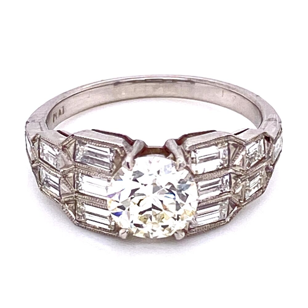 This ring is a super cool Art Deco engagement ring with side baguette diamonds, engraving & milgrain that go half way down the shank! The center is an Old European Cut round brilliant diamond that weighs 1.15ct. Platinum Art Deco 1.15ct OEC Diamond Ring with Baguette sides 5.0g