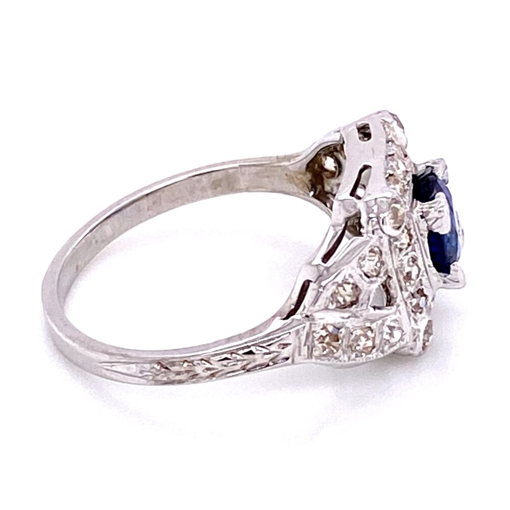 One round 1.05ct Kashmir blue color sapphire sits in the center of this beautiful 100 year old ring! The surrounding single cut diamonds are are of the Art Deco period; some are prong set and some bezel set. Milgrain on top and engraving down the shank make this a truly special and wearable ring! It needs a home for the next 100 years! 18K WG Art Deco Sapphire & Diamond Ring, s6.5