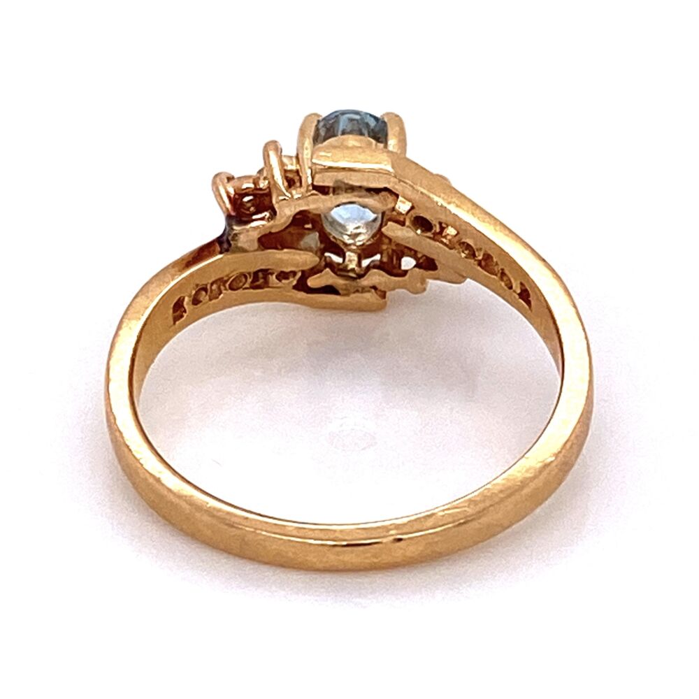 Classic, petite and easy to wear ring with a center oval aquamarine weighing approx. .25ct and 12 round brilliant diamonds weighing approx. .10tcw. The 14K yellow gold is rich in color and would make the perfect gift! 14K YG Oval Aquamarine & Diamond Bypass Shank Ring 3.0g, s6.5