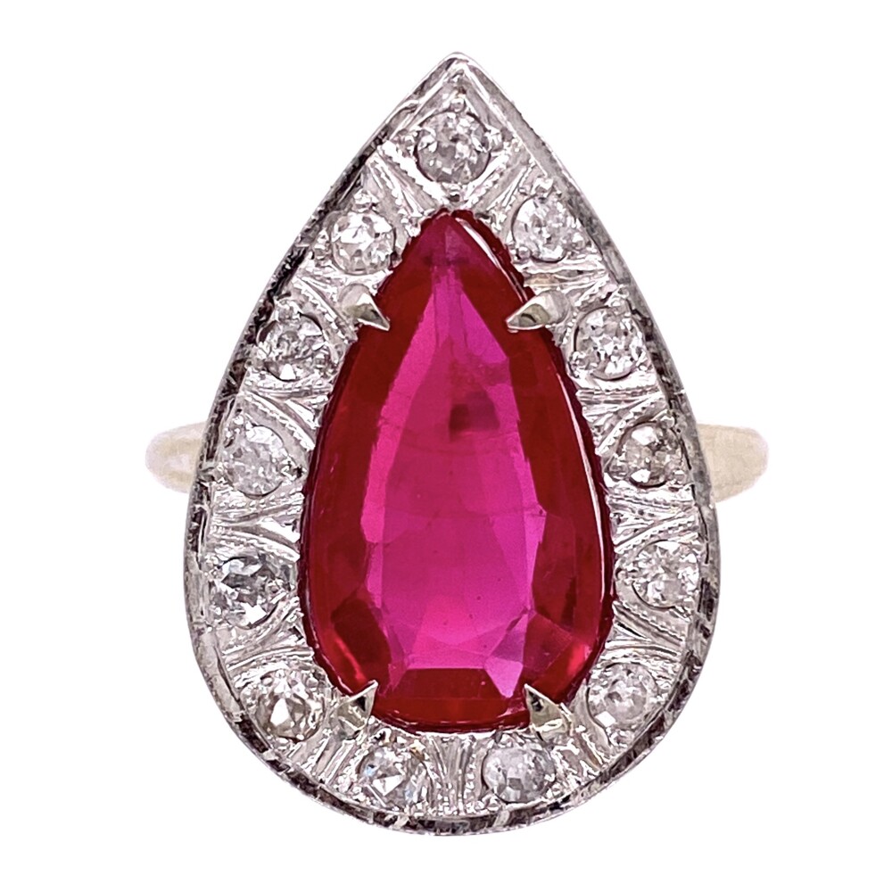 This custom mounting is super cool with 13 round diamonds weighing approx. .65tcw surrounding an lab grown Ruby approx. 3.5ct<div style="position: initial; margin: initial;"><span style="font-size: 16.8px; position: initial; margin: initial;"><a href="https://youtu.be/s8RG4kw1e4U" title="https://youtu.be/s8RG4kw1e4U" style="text-decoration: none;">https://youtu.be/s8RG4kw1e4U</a></span><br style="position: initial; margin: initial;"></div> 14K WG Synthetic Pear Shape Ruby & Diamond Ring, 9.0g