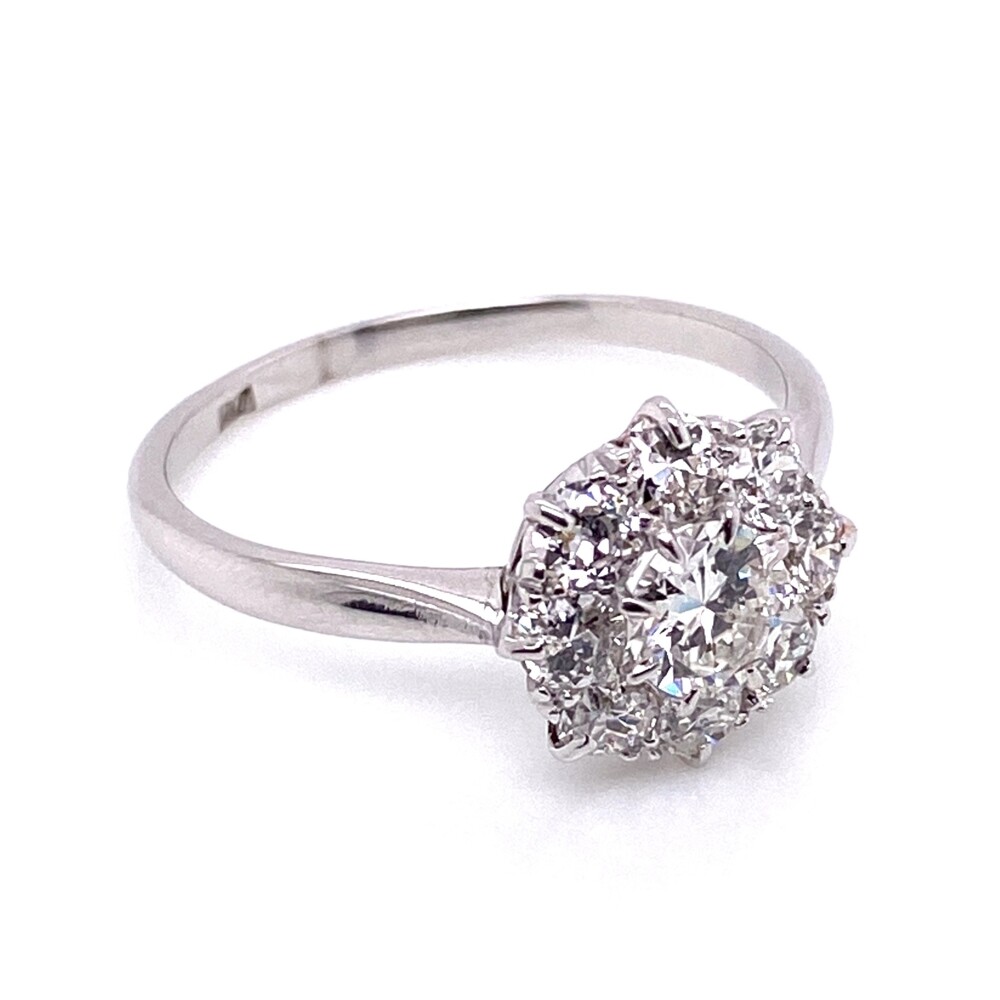 H/I Color, Vs2-SI1 Clarity average. Center measures 5.3mm and is about a .55ct round brilliant with a cut typical of the 1950's.<div style="position: initial; margin: initial;"><span style="font-size: 16.8px; position: initial; margin: initial;"><a href="https://youtu.be/3a69VE2hWd4" title="https://youtu.be/3a69VE2hWd4" style="text-decoration: none;">https://youtu.be/3a69VE2hWd4</a></span><br style="position: initial; margin: initial;"></div> Platinum Mid-Century 1.30tcw Cluster Diamond Ring