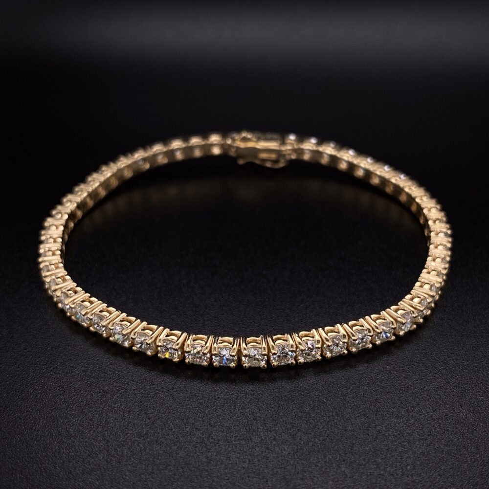 Beautiful & Classic, this yellow gold straight line four prong diamond tennis bracelet has 82 natural round brilliant diamonds weighing 1.76tcw. 6.1g gross weight and 7" long 14K YG Straight Line Diamond Tennis Bracelet 7.04tcw, 7"