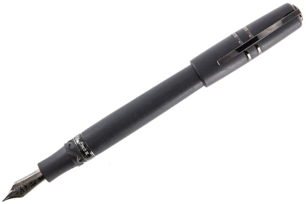 The Homo Sapiens fountain pen is handmade from hardened basaltic lava sourced from the Mount Etna volcano in Italy, with an all-black pen cap using the Visconti 'Hook Safe Lock'. The fountain pen's vacuum power filler is made of titanium to resist ink corrosion, and it features a black 18kt gold nib. Visconti Homo Sapiens Fountain Pen in Dark Age