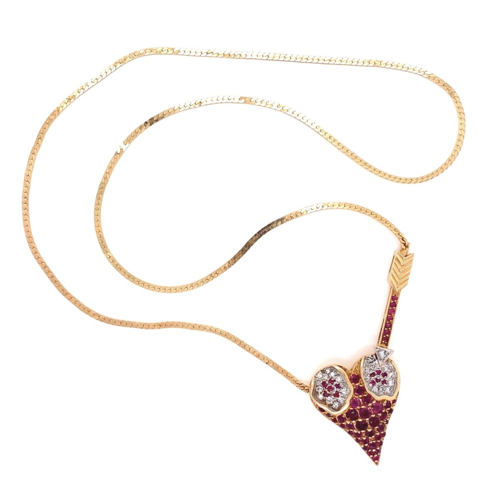 Stamped on the back, "ERTE, CFA, 14K, 44/500
This is a great ERTE piece with the arrow going through the heart, 22 round diamonds are approx. .23tcw & 53 rubies are approx 2.50tcw 14K YG ERTE L'Amour Heart Pendant Rubies & Diamonds 14.2g, 18"