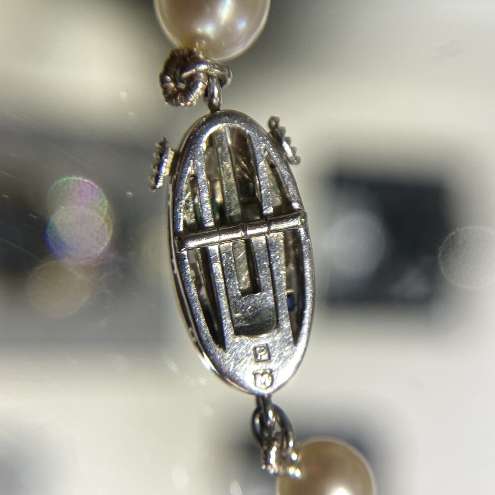 Stamped, "M" and "P" & tested 80% platinum which is typical Japanese platinum. This piece dates to c1920's and has an amazing clasp with rose cut diamonds, French cut sapphires & Ruby. This is a super rare MIKIMOTO find! Platinum Mikimoto Art Deco Pearl Strand 8.7-4.7mm Diamonds, Ruby, Sapphire Clasp 21"