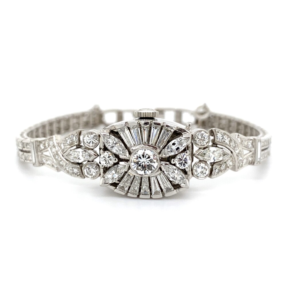 This super cool 1950's diamond bracelet also happens to be a watch! It has 144 single cut round diamonds approx. 2.75tcw, 7 full cut round diamonds approx. 1.10tcw, 6 marquis approx. .90tcw & 10 baguette diamonds approx. .75tcw. Total diamond weight is approx. 5.50tcw. 1950's Platinum Diamond Hamilton Watch Bracelet 5.50tcw 36.5g, 7.5"