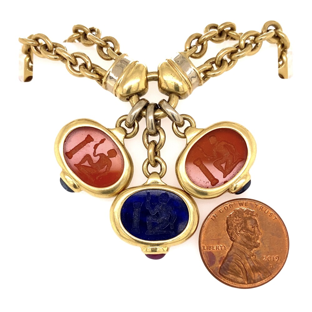 This Italian stamped piece is has a double chain link chain design with 3 stations each having carvings hanging. Each carnelian carving is bezel set and has a cabochon sapphire at the bottom & each lapis carving is bezel set and has a cabochon ruby at the bottom. This necklace is very well made and is stamped, "Italy, 18K & 1932AL". 18K YG Italian Carved Lapis & Carnelian Necklace 84.6g, 16"