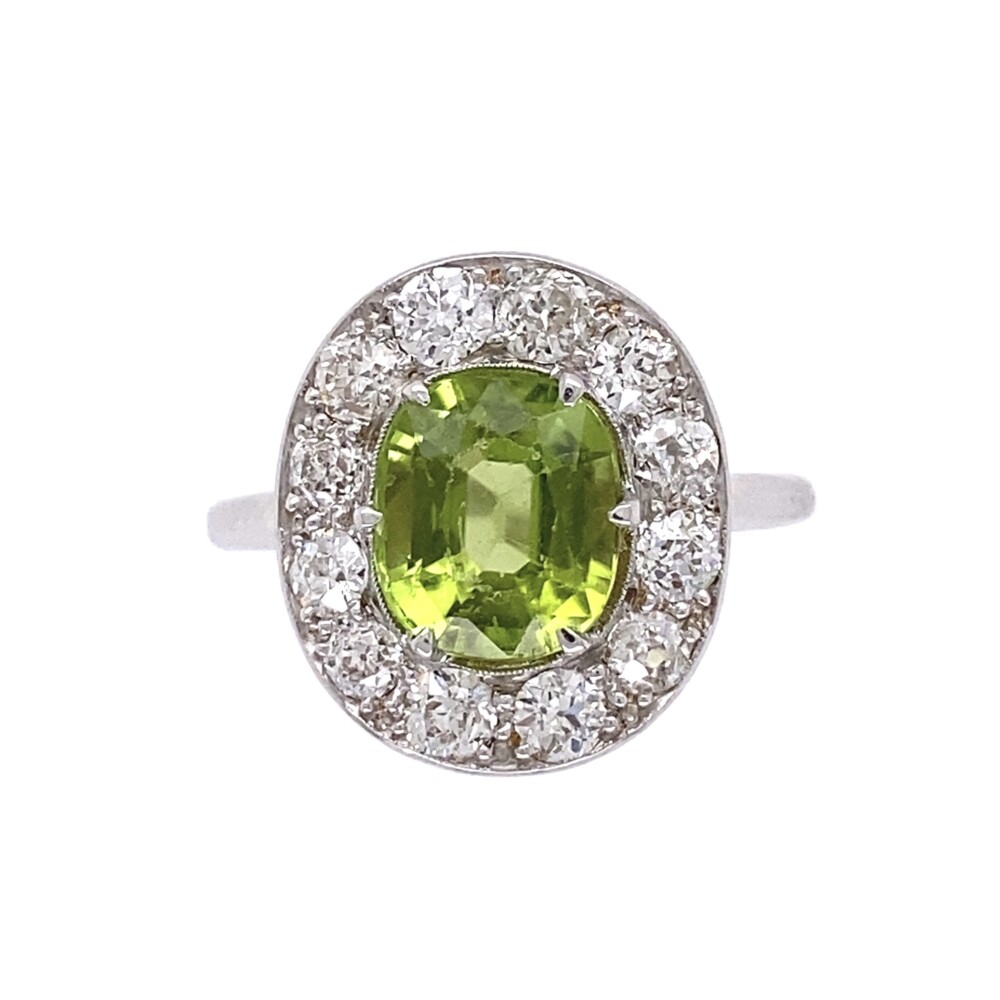 1 Old cut oval natural green peridot is the centerpiece of this ring and 12 old european cut diamonds surrounding are approx. .84tcw all done in high quality 18K white gold with cut out details on the undergallery. 18K WG Art Deco 2ct Oval Peridot & .84tcw Diamond Ring 3.5g, s6.5
