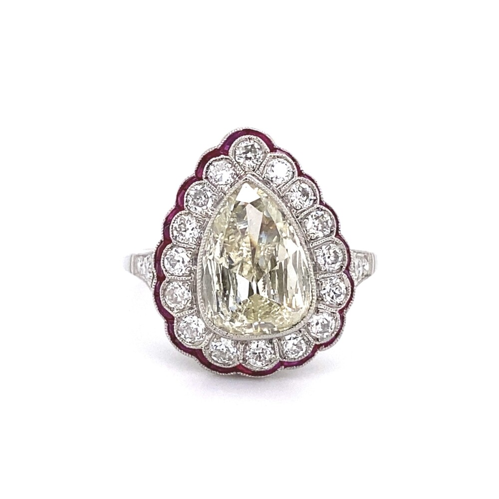 Check out this amazing handmade ring in platinum! The center antique pear shape is approx. 1.75ct, but faces huge - equivalent to a 2.5-3ct. The are 22 old European cut round diamonds weighing approx. .66tcw and custom French cut natural rubies weighing approx. 2.00tcw. Platinum Art Deco 1.75ct Antique Pear Diamond & Ruby Ring 5.9g, s7
