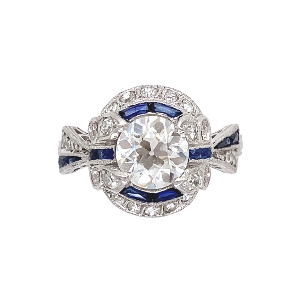 Check out this amazing Art Deco ring set on a bias in handmade platinum with plenty of milgrain and engraving! The center old European cut diamond is approx. 1.23ct, H/I color, SI1 clarity judged, calibre sapphires around & on opposing side of the shank are approx. .30tcw and side old cut diamonds approx. .20tcw. Art Deco Platinum 1.23ct Diamond & Sapphire Ring, s6.5