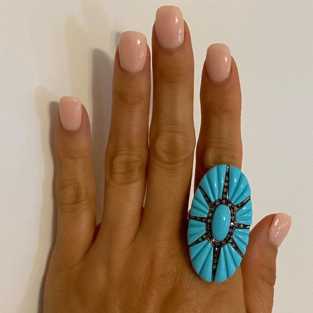 Check out this fantastic turquoise ring with an oval turquoise in the center, an eight ray star extending out of 35 rose cut diamonds approx. .25tcw and 8 carved turquoise section outside the star making this a beautiful design and a large statement ring! 15K YG Large Turquoise & Diamond Star Burst Ring 16.9g, s8.5