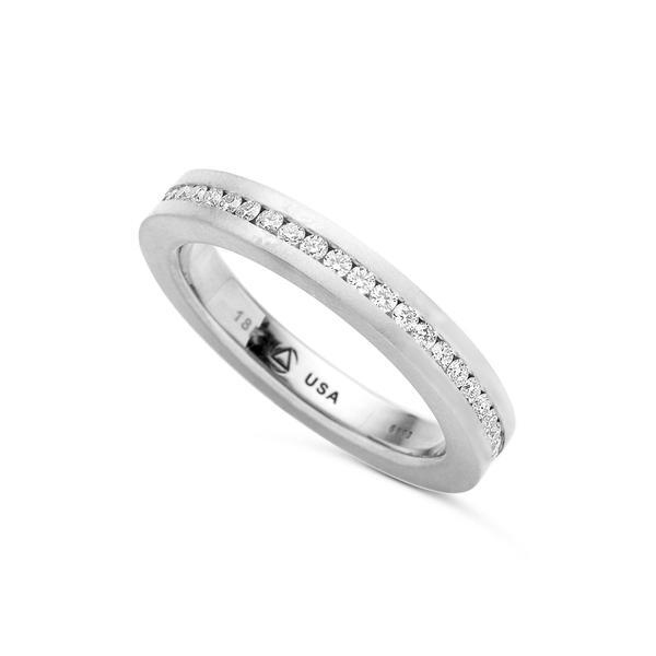 In stock, U.S. size 6.5, with a matte finish in platinum. The Square Channel Band is designed to be paired with any of our Hard Omega (HO)-style rings or worn separately. A channel of melee extends all the way around the band. Available from 3.00mm to 5.00mm in width, in platinum and 18-karat yellow, rose, or white gold. Call for pricing variations. Square Channel Band Matte Pt950 6.9g 3 mm