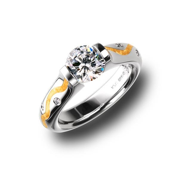 Iin stock, U.S. size 6.75, set with a 7.0 mm round CZ. The Omega Round with 24-karat gold wiggley stripe inlay is offered exclusively in platinum with yellow gold inlay. This ring features 8 diamond melee and has a shiny finish. Center Stone NOT included. All rings are made to order based upon center stone and finger size. Call for pricing variations. Omega Round Wiggley Pt950 24k 13.7g 7.0mm