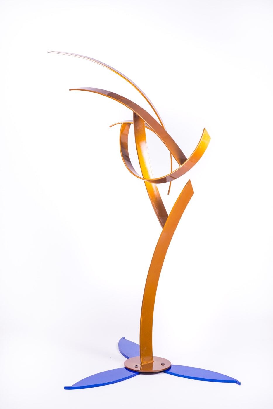This elegant orange/yellow sculpture by artist Miguel Edwards is made of steel with a metal flake powder coat. Levity explores underlying forms and concepts intrinsic in the dynamic between our sleeping and waking lives — as well as the visual logic of human perception. Levity