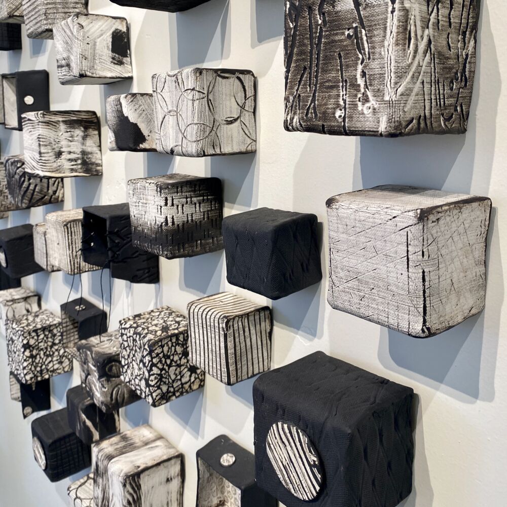 This beautiful ceramic wall sculpture by Jodi Walsh was created through a process called oritatami nendo, or folding clay. Inspired by nature, Cubes (Medium) recreates the intimate connection we all feel to nature. Cubes Medium