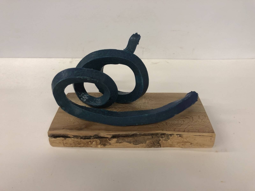 This sculpture by artist Brandon Reese beautifully combines glazed stoneware and sycamore. Deep Turquoise Spiral shows that one element can bring out the characteristics of the other. Deep Turquoise Spiral