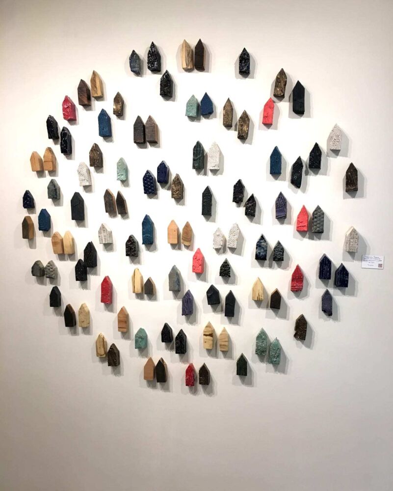 This piece of wall art by Brandon Reese combines glazed stoneware and wood for a spectacular visual effect. Red Barrel Community represents the artist's fascination with the patterns and imperfections found within nature. Red Barrel Community