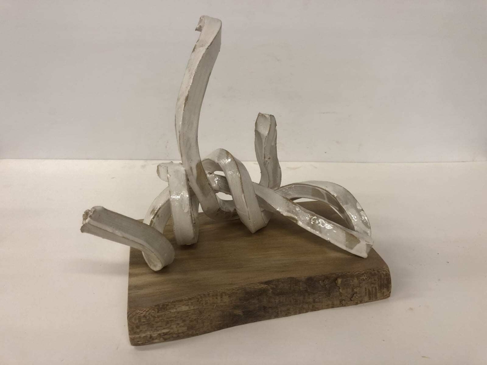 This sculpture by artist Brandon Reese beautifully combines glazed stoneware and sycamore. Ivory Twist shows that one element can bring out the characteristics of the other. Ivory Twist