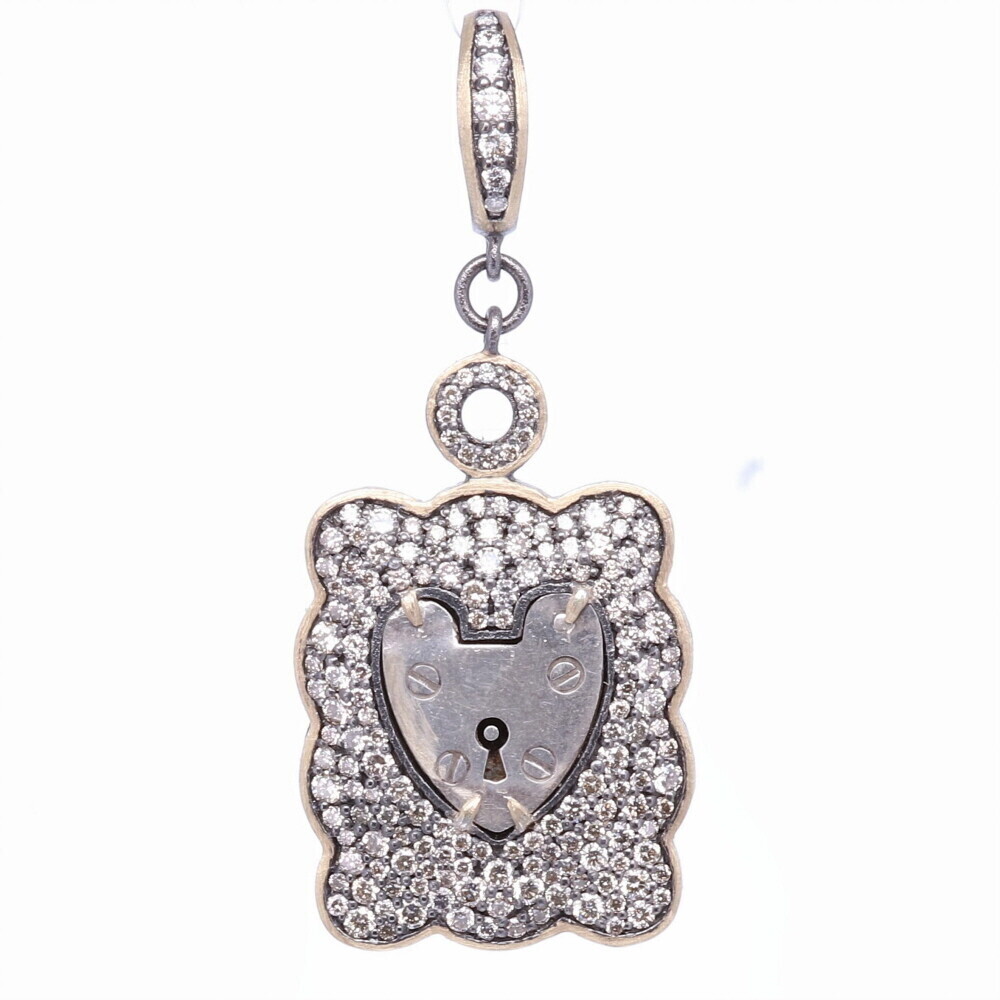 The Antique English padlock was typically worn on a bracelet and given to a loved one to show how much they were loved. Before going off to war, gentlemen would leave the bracelet locked around his loved one’s wrist and he would hold the key until his return. The heart shaped padlock was fashionable in the Victorian and Edwardian periods.
Small Vintage English London Padlock, Surrounded by a Champagne Diamond, 14k Yellow Gold and Black Rhodium Wide Pave Scalloped Bezel, Hanging from a Champage Diamond, 14k Gold and Black Rhodium Openable Bale.
173 Champagne Diamonds - 1.80tcw
14k Gold - 3.32g
Black Rhodium Silver London Framed Vintage Padlock