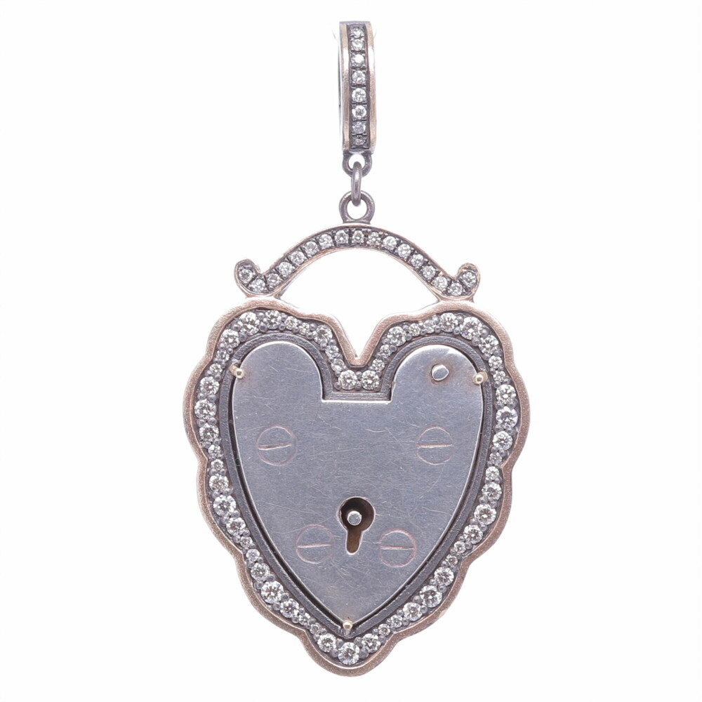 The Antique English padlock was typically worn on a bracelet and given to a loved one to show how much they were loved. Before going off to war, gentlemen would leave the bracelet locked around his loved one’s wrist and he would hold the key until his return. Heart shaped padlocks were fashionable in the Victorian and Edwardian periods. This original antique padlock is set in a Cynthia Ann diamond bezel.
Large Vintage Padlock, Surrounded by a Champagne Diamond, 14k Yellow Gold and Black Rhodium Scalloped Bezel, Hanging from a Champagne Diamond, 14k Gold and Black Rhodium Openable Bale.
Champagne Diamond - 0.80cts
14k Gold - 7.37g Old English Padlock Pendant