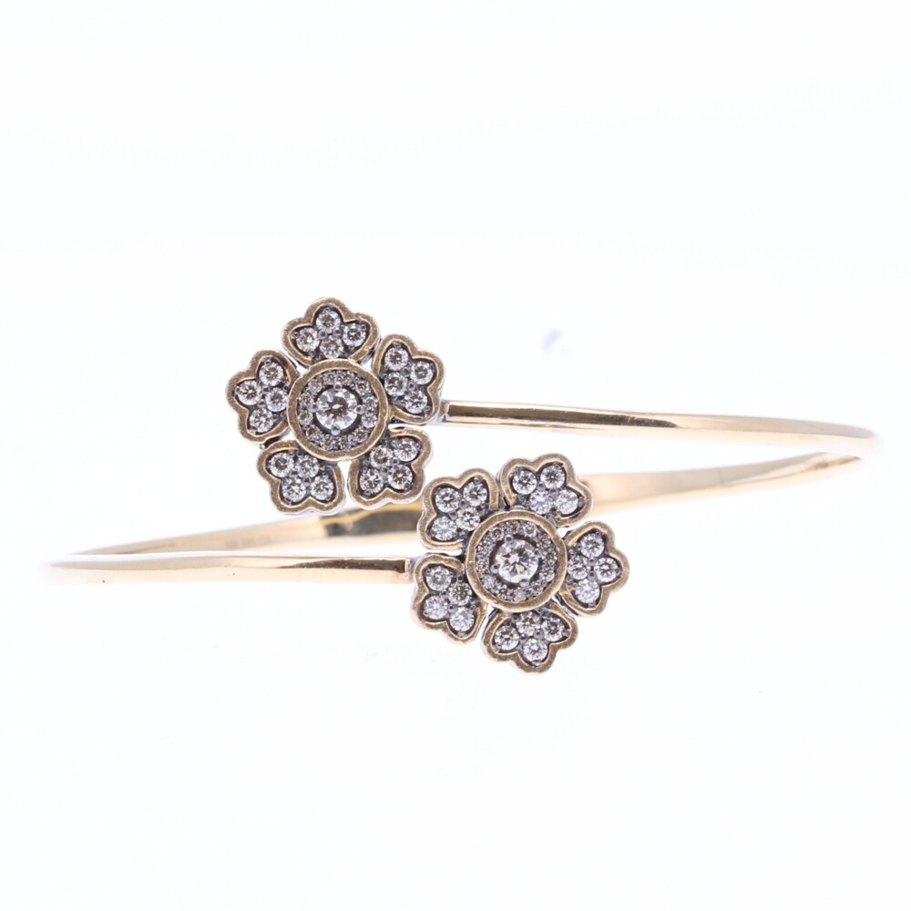 This floral hinged cuff bracelet is constructed of 14k yellow gold 8.77g, champagne diamonds 2.00, and rhodium sterling silver. Floral Hinged Cuff Bracelet
