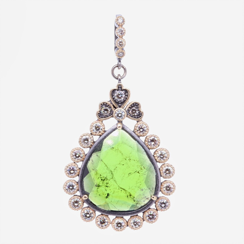 This gorgeous deep green tourmaline stone has been set inside a unique diamond bezel. The bale has a 4mm opening. Theres 1.60 carats of Diamonds, 14k Yellow Gold 6.52g, and rhodium sterling silver. Green Tourmaline Pendant