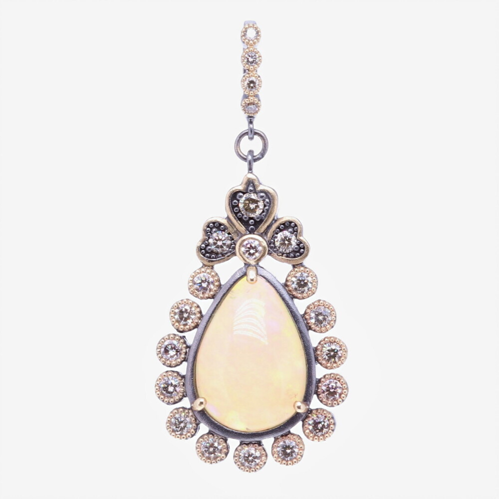 This beautiful pear shaped opal is set in a unique diamond bezel. The diamond weight is 1.1 tcw, 14k yellow gold 5.88g, and rhodium sterling silver. Pear Shaped Opal Pendant