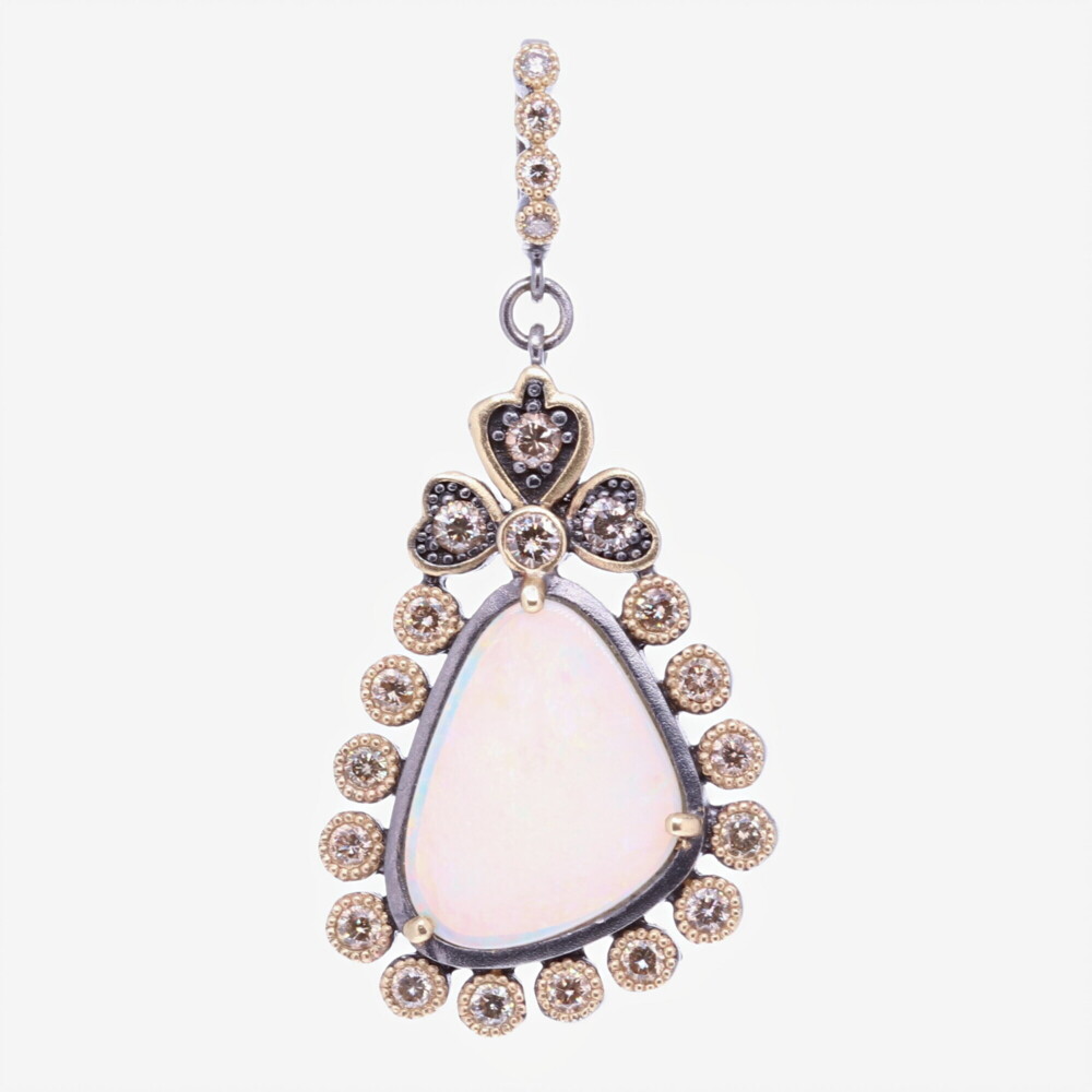 This Cynthia Ann classically styled dot bezel is framing this asymmetrical opal. The bezel has 1.28 TCW Diamonds, 14k Yellow gold 6.82g, and Rhodium Sterling Silver. The bale has a 4mm opening, allowing you to clip the pendant on different necklaces. Asymmetrical Opal Pendant