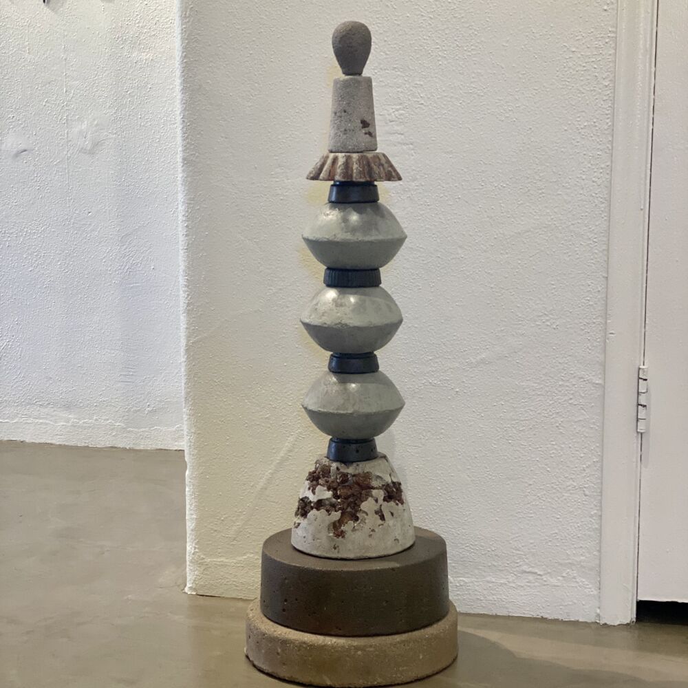 This bold concrete sculpture was created by Steve Bramon, a third-generation bricklayer. Flow Concrete Totem represents both the delicacy and the strength of the artist's medium. Flow Concrete Totem