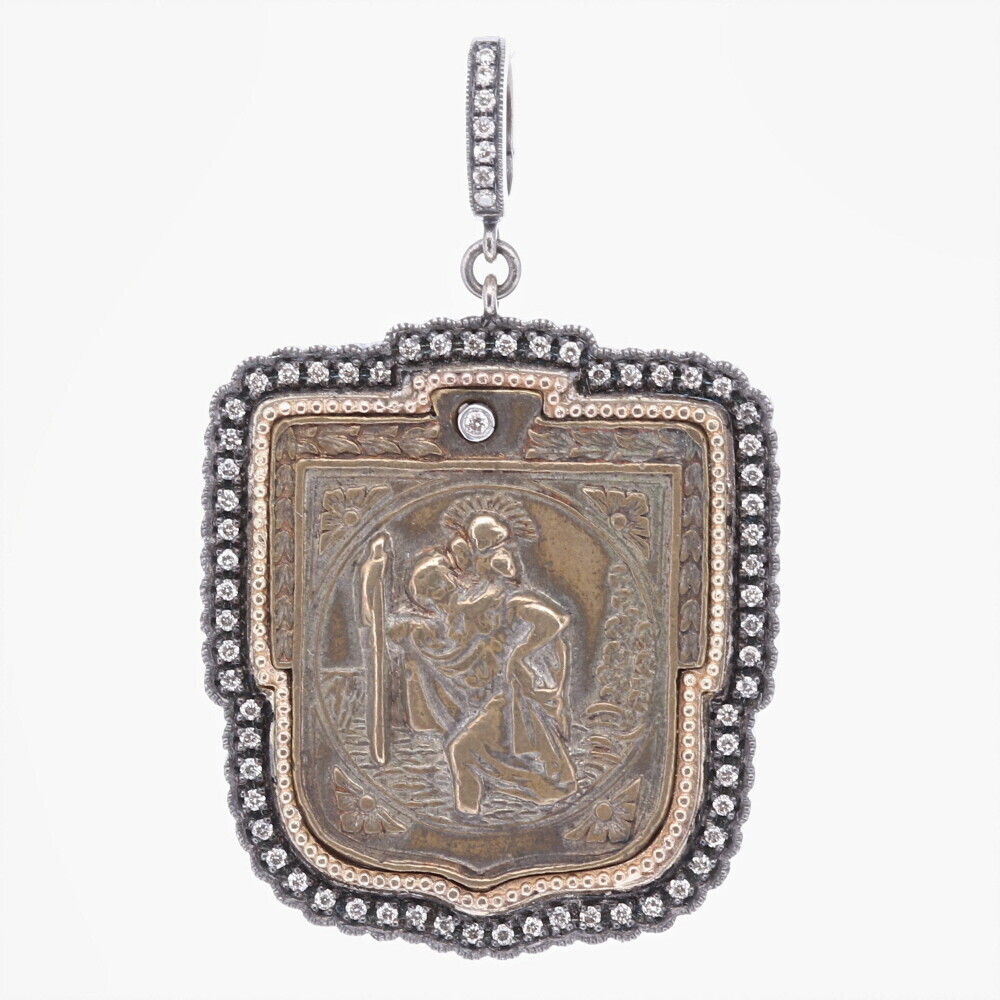 This beautiful antique medal represents St. Christopher and the iconic image "The Gentle Giant In The River". He was consulted by a wise old man that suggested he should use his strength to help people cross the dangerous river (where many lost their lives). Christopher thought providing this service would be pleasing to Christ. Christopher was eagerly preforming this task when a child asked for help to cross the river. As Christopher carried him on his shoulder, the child got heavier and heavier. When they got to the other side of the riverbank, Christopher asked the Child who he was. It turns out the child was Christ himself. This medal is set in a Rhodium sterling silver and Diamond 0.48 tcw bezel with a bale that has a 4mm opening. Antique St. Christopher "The Gentle Giant in The River" Pendant