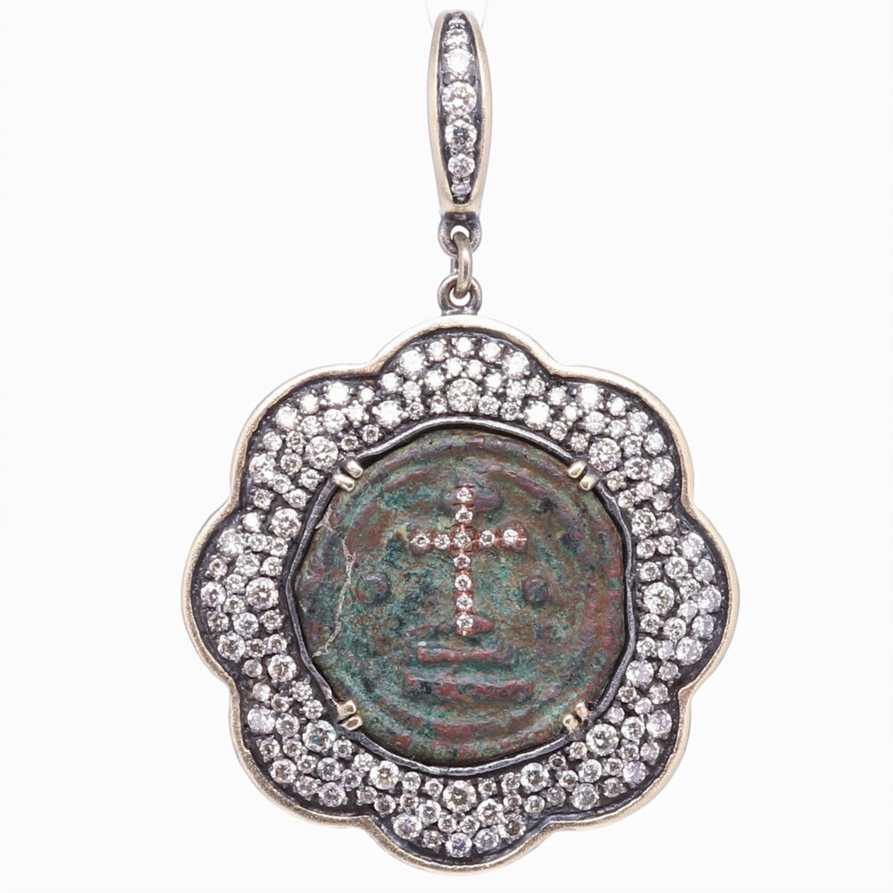 The coinage of the Byzantine Empire functioned as a convenient method of payment for goods and services, especially to soldiers and officials, and as a means for people to pay their taxes. Byzantine currency, used in the Eastern Roman Empire after the fall of the West, consisted of mainly two types of coins: the gold solidus and a variety of clearly valued bronze coins. On the front of early Byzantine coins was the head of the Emperor, now full face rather than in profile, and on the reverse, usually a Christian symbol such as the cross, or a Victory or an angel (the two tending to merge into one another). By the end of the empire the currency was issued only in silver and minor copper coins. Ancient Byzantine Coin Pendant