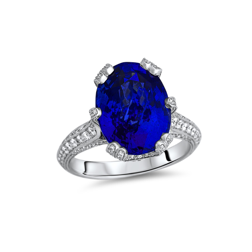 18Kt WG Ring set w/ an 8.56 ct Oval Ceylon Blue Sapphire and 0.85 ctw of Diamonds on the Prongs and Band Ring