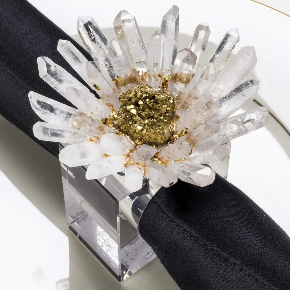 <font size="4"><span style="font-family: "EB Garamond";">Quartz & Coated Gold Geode Flower Napkin Holder 4pc Set</span></font><div style="position: initial; margin: initial; font-family: "EB Garamond";"><font size="4"><br style="position: initial; margin: initial; font-family: "EB Garamond";"></font></div><div style="position: initial; margin: initial; font-family: "EB Garamond";"><p style="margin: initial; padding: 0px; border: 0px; font-family: "EB Garamond"; font-stretch: inherit; line-height: inherit; vertical-align: baseline; caret-color: rgb(51, 51, 51); color: rgb(51, 51, 51); text-size-adjust: auto; position: initial;"><span style="margin: initial; padding: 0px; border: 0px; font-family: "EB Garamond"; font-style: inherit; font-variant-caps: inherit; font-weight: inherit; font-stretch: inherit; line-height: inherit; vertical-align: baseline; position: initial;"><font size="4">For an elegant table setting, these crystal napkin rings are furnished with fine gemstones to make a beautifully decorative piece for all spaces. Included in this set is (4) individual napkin holders.</font></span></p><p style="margin: initial; padding: 0px; border: 0px; font-family: "EB Garamond"; font-stretch: inherit; line-height: inherit; vertical-align: baseline; caret-color: rgb(51, 51, 51); color: rgb(51, 51, 51); text-size-adjust: auto; position: initial;"><span style="margin: initial; padding: 0px; border: 0px; font-family: "EB Garamond"; font-style: inherit; font-variant-caps: inherit; font-weight: inherit; font-stretch: inherit; line-height: inherit; vertical-align: baseline; position: initial;"><font size="4">Despite their delicate look, our Gemstone Napkin Rings are incredibly sturdy to ensure they will be treasured for years to come.</font></span></p><p style="margin: initial; padding: 0px; border: 0px; font-family: "EB Garamond"; font-stretch: inherit; line-height: inherit; vertical-align: baseline; caret-color: rgb(51, 51, 51); color: rgb(51, 51, 51); text-size-adjust: auto; position: initial;"><span style="margin: initial; padding: 0px; border: 0px; font-family: "EB Garamond"; font-style: inherit; font-variant-caps: inherit; font-weight: inherit; font-stretch: inherit; line-height: inherit; vertical-align: baseline; position: initial;"><font size="4">The quartz elestials are hand-placed on top of the acrylic ring by master craftsmen to create the highest quality of functionality. All gemstones used are 100% natural; therefore, please allow for slight variation in color and shape.</font></span></p><p style="margin: initial; padding: 0px; border: 0px; font-family: "EB Garamond"; font-stretch: inherit; line-height: inherit; vertical-align: baseline; caret-color: rgb(51, 51, 51); color: rgb(51, 51, 51); text-size-adjust: auto; position: initial;"><span style="margin: initial; padding: 0px; border: 0px; font-family: "EB Garamond"; font-style: inherit; font-variant-caps: inherit; font-weight: inherit; font-stretch: inherit; line-height: inherit; vertical-align: baseline; position: initial;"><font size="4">The Quartz elestials hold powerful healing properties and are loved for their ability to:</font></span></p><ul style="margin: initial; padding: 0px; border: 0px; font-family: "EB Garamond"; font-stretch: inherit; line-height: inherit; vertical-align: baseline; caret-color: rgb(51, 51, 51); color: rgb(51, 51, 51); text-size-adjust: auto; position: initial;"><li style="margin: initial; padding: 0px; border: 0px; font-family: "EB Garamond"; font-style: inherit; font-variant-caps: inherit; font-weight: inherit; font-stretch: inherit; line-height: inherit; vertical-align: baseline; list-style: outside disc; position: initial;"><div style="margin: initial; padding: 0px; border: 0px; font-family: "EB Garamond"; font-style: inherit; font-variant-caps: inherit; font-weight: inherit; font-stretch: inherit; line-height: inherit; vertical-align: baseline; position: initial;"><font size="4">Bring peace.</font></div></li><li style="margin: initial; padding: 0px; border: 0px; font-family: "EB Garamond"; font-style: inherit; font-variant-caps: inherit; font-weight: inherit; font-stretch: inherit; line-height: inherit; vertical-align: baseline; list-style: outside disc; position: initial;"><div style="margin: initial; padding: 0px; border: 0px; font-family: "EB Garamond"; font-style: inherit; font-variant-caps: inherit; font-weight: inherit; font-stretch: inherit; line-height: inherit; vertical-align: baseline; position: initial;"><font size="4">Alleviate stress and anxiety.</font></div></li><li style="margin: initial; padding: 0px; border: 0px; font-family: "EB Garamond"; font-style: inherit; font-variant-caps: inherit; font-weight: inherit; font-stretch: inherit; line-height: inherit; vertical-align: baseline; list-style: outside disc; position: initial;"><div style="margin: initial; padding: 0px; border: 0px; font-family: "EB Garamond"; font-style: inherit; font-variant-caps: inherit; font-weight: inherit; font-stretch: inherit; line-height: inherit; vertical-align: baseline; position: initial;"><font size="4">Amplify your energy and intentions.</font></div></li></ul><p style="margin: initial; padding: 0px; border: 0px; font-family: "EB Garamond"; font-stretch: inherit; line-height: inherit; vertical-align: baseline; caret-color: rgb(51, 51, 51); color: rgb(51, 51, 51); text-size-adjust: auto; position: initial;"><font size="4">Ring Top Dimensions: 3" x 3"</font></p><p style="margin: initial; padding: 0px; border: 0px; font-family: "EB Garamond"; font-stretch: inherit; line-height: inherit; vertical-align: baseline; caret-color: rgb(51, 51, 51); color: rgb(51, 51, 51); text-size-adjust: auto; position: initial;"><font size="4">Napkin Hole Dimensions: 1.25" x 1.25"</font></p><p style="margin: initial; padding: 0px; border: 0px; font-family: "EB Garamond"; font-stretch: inherit; line-height: inherit; vertical-align: baseline; caret-color: rgb(51, 51, 51); color: rgb(51, 51, 51); text-size-adjust: auto; position: initial;"><font size="4">Ring Height: 3"</font></p><p style="margin: initial; padding: 0px; border: 0px; font-family: "EB Garamond"; font-stretch: inherit; line-height: inherit; vertical-align: baseline; caret-color: rgb(51, 51, 51); color: rgb(51, 51, 51); text-size-adjust: auto; position: initial;"><font size="4">Your set will arrive safely packaged in a gift box for safe keeping and gifting to your friends and family.</font></p><p style="margin: initial; padding: 0px; border: 0px; font-family: "EB Garamond"; font-stretch: inherit; line-height: inherit; vertical-align: baseline; caret-color: rgb(51, 51, 51); color: rgb(51, 51, 51); text-size-adjust: auto; position: initial;"><font size="4">Your satisfaction is 100% guaranteed with our 30 day-money back warranty.</font></p></div> Quartz & Coated Gold Geode Flower Napkin Holder 4pc Set