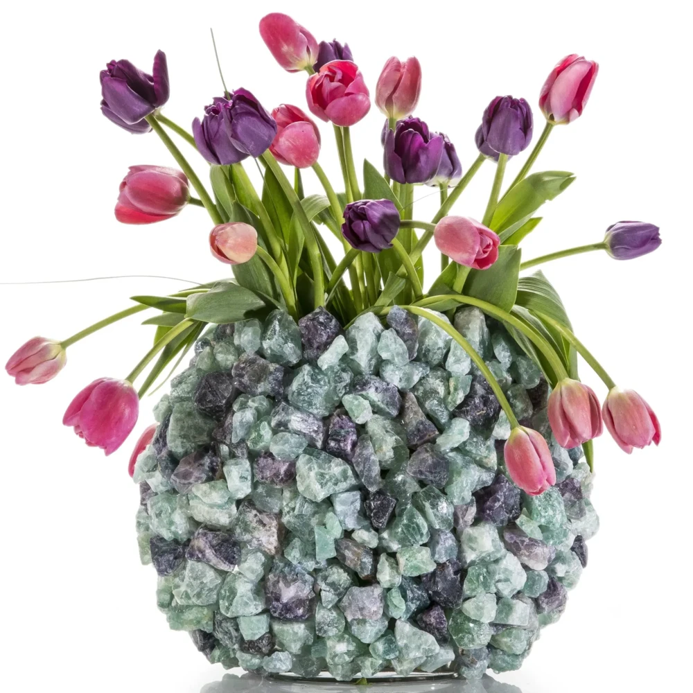 <font size="4"><span style="font-family: "EB Garamond";">Fluorite Gemstone Vase -Oval</span></font><div style="position: initial; margin: initial; font-family: "EB Garamond";"><font size="4"><br style="position: initial; margin: initial; font-family: "EB Garamond";"></font></div><div style="position: initial; margin: initial; font-family: "EB Garamond";"><p style="margin: initial; padding: 0px; border: 0px; font-family: "EB Garamond"; font-stretch: inherit; line-height: inherit; vertical-align: baseline; caret-color: rgb(51, 51, 51); color: rgb(51, 51, 51); text-size-adjust: auto; position: initial;"><font size="4">Original, hand-made Fluorite vase. </font></p><p style="margin: initial; padding: 0px; border: 0px; font-family: "EB Garamond"; font-stretch: inherit; line-height: inherit; vertical-align: baseline; caret-color: rgb(51, 51, 51); color: rgb(51, 51, 51); text-size-adjust: auto; position: initial;"><font size="4">Fluorite is believed to:</font></p><ul style="margin: initial; padding: 0px; border: 0px; font-family: "EB Garamond"; font-stretch: inherit; line-height: inherit; vertical-align: baseline; caret-color: rgb(51, 51, 51); color: rgb(51, 51, 51); text-size-adjust: auto; position: initial;"><li style="margin: initial; padding: 0px; border: 0px; font-family: "EB Garamond"; font-style: inherit; font-variant-caps: inherit; font-weight: inherit; font-stretch: inherit; line-height: inherit; vertical-align: baseline; list-style: outside disc; position: initial;"><font size="4">Absorbs and neutralizes negative energy and stress.</font></li><li style="margin: initial; padding: 0px; border: 0px; font-family: "EB Garamond"; font-style: inherit; font-variant-caps: inherit; font-weight: inherit; font-stretch: inherit; line-height: inherit; vertical-align: baseline; list-style: outside disc; position: initial;"><font size="4">Serve as an excellent learning aid.</font></li><li style="margin: initial; padding: 0px; border: 0px; font-family: "EB Garamond"; font-style: inherit; font-variant-caps: inherit; font-weight: inherit; font-stretch: inherit; line-height: inherit; vertical-align: baseline; list-style: outside disc; position: initial;"><font size="4">Increases powers of concentration & self-confidence.</font></li><li style="margin: initial; padding: 0px; border: 0px; font-family: "EB Garamond"; font-style: inherit; font-variant-caps: inherit; font-weight: inherit; font-stretch: inherit; line-height: inherit; vertical-align: baseline; list-style: outside disc; position: initial;"><font size="4">Aid in decision-making.</font></li></ul><p style="margin: initial; padding: 0px; border: 0px; font-family: "EB Garamond"; font-stretch: inherit; line-height: inherit; vertical-align: baseline; caret-color: rgb(51, 51, 51); color: rgb(51, 51, 51); text-size-adjust: auto; position: initial;"><font size="4">This vase can serve as a wonderful<span style="margin: initial; padding: 0px; border: 0px; font-family: "EB Garamond"; font-style: inherit; font-variant-caps: inherit; font-weight: inherit; font-stretch: inherit; line-height: inherit; vertical-align: baseline; position: initial;"> </span>addition to your Bedroom, Bathroom, Zen Den, and more! The glass center is perfect for holding a candle or a plant to bring energy, healing, and beauty into your space. </font></p><p style="margin: initial; padding: 0px; border: 0px; font-family: "EB Garamond"; font-stretch: inherit; line-height: inherit; vertical-align: baseline; caret-color: rgb(51, 51, 51); color: rgb(51, 51, 51); text-size-adjust: auto; position: initial;"><font size="4">Vase Dimensions: 13" W x 10" H</font></p><p style="margin: initial; padding: 0px; border: 0px; font-family: "EB Garamond"; font-stretch: inherit; line-height: inherit; vertical-align: baseline; caret-color: rgb(51, 51, 51); color: rgb(51, 51, 51); text-size-adjust: auto; position: initial;"><font size="4">Inner glass dimensions: 8" x 4.5"</font></p><p style="margin: initial; padding: 0px; border: 0px; font-family: "EB Garamond"; font-stretch: inherit; line-height: inherit; vertical-align: baseline; caret-color: rgb(51, 51, 51); color: rgb(51, 51, 51); text-size-adjust: auto; position: initial;"><font size="4">Weight: 7 kg / 15 lbs</font></p><p style="margin: initial; padding: 0px; border: 0px; font-family: "EB Garamond"; font-stretch: inherit; line-height: inherit; vertical-align: baseline; caret-color: rgb(51, 51, 51); color: rgb(51, 51, 51); text-size-adjust: auto; position: initial;"><span style="margin: initial; padding: 0px; border: 0px; font-family: "EB Garamond"; font-style: inherit; font-variant-caps: inherit; font-weight: inherit; font-stretch: inherit; line-height: inherit; vertical-align: baseline; position: initial;"><font size="4">Each vase is handmade with natural stones, so please allow for slight variations in size, shape, and color.</font></span></p></div> Fluorite Gemstone Vase -Oval