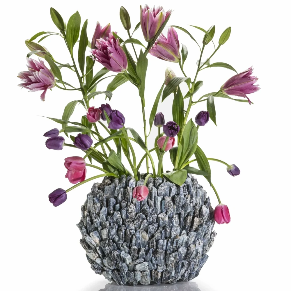<font size="4"><span style="font-family: "EB Garamond";">Kyanite Gemstone Vase -Oval</span></font><div style="position: initial; margin: initial; font-family: "EB Garamond";"><font size="4"><br style="position: initial; margin: initial; font-family: "EB Garamond";"></font></div><div style="position: initial; margin: initial; font-family: "EB Garamond";"><p style="margin: initial; padding: 0px; border: 0px; font-family: "EB Garamond"; font-stretch: inherit; line-height: inherit; vertical-align: baseline; caret-color: rgb(51, 51, 51); color: rgb(51, 51, 51); text-size-adjust: auto; position: initial;"><font size="4">Original, hand-made Kyanite vase. </font></p><p style="margin: initial; padding: 0px; border: 0px; font-family: "EB Garamond"; font-stretch: inherit; line-height: inherit; vertical-align: baseline; caret-color: rgb(51, 51, 51); color: rgb(51, 51, 51); text-size-adjust: auto; position: initial;"><font size="4">Kyanite is believed to:</font></p><ul style="margin: initial; padding: 0px; border: 0px; font-family: "EB Garamond"; font-stretch: inherit; line-height: inherit; vertical-align: baseline; caret-color: rgb(51, 51, 51); color: rgb(51, 51, 51); text-size-adjust: auto; position: initial;"><li style="margin: initial; padding: 0px; border: 0px; font-family: "EB Garamond"; font-style: inherit; font-variant-caps: inherit; font-weight: inherit; font-stretch: inherit; line-height: inherit; vertical-align: baseline; list-style: outside disc; position: initial;"><font size="4">Unlock your chakras.</font></li><li style="margin: initial; padding: 0px; border: 0px; font-family: "EB Garamond"; font-style: inherit; font-variant-caps: inherit; font-weight: inherit; font-stretch: inherit; line-height: inherit; vertical-align: baseline; list-style: outside disc; position: initial;"><font size="4">Open up your energy blockages and allow the free-flow of your positive energy throughout your body.</font></li><li style="margin: initial; padding: 0px; border: 0px; font-family: "EB Garamond"; font-style: inherit; font-variant-caps: inherit; font-weight: inherit; font-stretch: inherit; line-height: inherit; vertical-align: baseline; list-style: outside disc; position: initial;"><font size="4">Bring tranquility & peace.</font></li></ul><p style="margin: initial; padding: 0px; border: 0px; font-family: "EB Garamond"; font-stretch: inherit; line-height: inherit; vertical-align: baseline; caret-color: rgb(51, 51, 51); color: rgb(51, 51, 51); text-size-adjust: auto; position: initial;"><font size="4">This vase can serve as a wonderful<span style="margin: initial; padding: 0px; border: 0px; font-family: "EB Garamond"; font-style: inherit; font-variant-caps: inherit; font-weight: inherit; font-stretch: inherit; line-height: inherit; vertical-align: baseline; position: initial;"> </span>addition to your Bedroom, Bathroom, Zen Den, and more! The glass center is perfect for holding a candle or a plant to bring energy, healing, and beauty into your space. </font></p><p style="margin: initial; padding: 0px; border: 0px; font-family: "EB Garamond"; font-stretch: inherit; line-height: inherit; vertical-align: baseline; caret-color: rgb(51, 51, 51); color: rgb(51, 51, 51); text-size-adjust: auto; position: initial;"><font size="4">Vase Dimensions: 13" W x 10" H</font></p><p style="margin: initial; padding: 0px; border: 0px; font-family: "EB Garamond"; font-stretch: inherit; line-height: inherit; vertical-align: baseline; caret-color: rgb(51, 51, 51); color: rgb(51, 51, 51); text-size-adjust: auto; position: initial;"><font size="4">Inner glass dimensions: 8" x 4.5"</font></p><p style="margin: initial; padding: 0px; border: 0px; font-family: "EB Garamond"; font-stretch: inherit; line-height: inherit; vertical-align: baseline; caret-color: rgb(51, 51, 51); color: rgb(51, 51, 51); text-size-adjust: auto; position: initial;"><font size="4">Weight: 7 kg / 15 lbs</font></p><p style="margin: initial; padding: 0px; border: 0px; font-family: "EB Garamond"; font-stretch: inherit; line-height: inherit; vertical-align: baseline; caret-color: rgb(51, 51, 51); color: rgb(51, 51, 51); text-size-adjust: auto; position: initial;"><span style="margin: initial; padding: 0px; border: 0px; font-family: "EB Garamond"; font-style: inherit; font-variant-caps: inherit; font-weight: inherit; font-stretch: inherit; line-height: inherit; vertical-align: baseline; position: initial;"><font size="4">Each vase is handmade with natural stones, so please allow for slight variations in size, shape, and color.</font></span></p></div> Kyanite Gemstone Vase -Oval