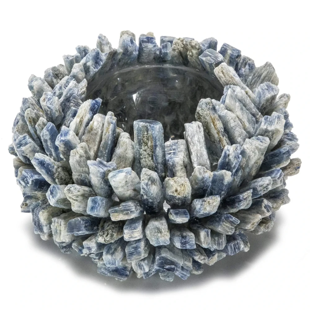<font size="4"><span style="font-family: "EB Garamond";">Kyanite Gemstone Vase -Round</span></font><div style="position: initial; margin: initial; font-family: "EB Garamond";"><font size="4"><br style="position: initial; margin: initial; font-family: "EB Garamond";"></font></div><div style="position: initial; margin: initial; font-family: "EB Garamond";"><p style="margin: initial; padding: 0px; border: 0px; font-family: "EB Garamond"; font-stretch: inherit; line-height: inherit; vertical-align: baseline; caret-color: rgb(51, 51, 51); color: rgb(51, 51, 51); text-size-adjust: auto; position: initial;"><font size="4">Original, hand-made Kyanite vase. </font></p><p style="margin: initial; padding: 0px; border: 0px; font-family: "EB Garamond"; font-stretch: inherit; line-height: inherit; vertical-align: baseline; caret-color: rgb(51, 51, 51); color: rgb(51, 51, 51); text-size-adjust: auto; position: initial;"><font size="4">Kyanite is believed to:</font></p><ul style="margin: initial; padding: 0px; border: 0px; font-family: "EB Garamond"; font-stretch: inherit; line-height: inherit; vertical-align: baseline; caret-color: rgb(51, 51, 51); color: rgb(51, 51, 51); text-size-adjust: auto; position: initial;"><li style="margin: initial; padding: 0px; border: 0px; font-family: "EB Garamond"; font-style: inherit; font-variant-caps: inherit; font-weight: inherit; font-stretch: inherit; line-height: inherit; vertical-align: baseline; list-style: outside disc; position: initial;"><font size="4">Unlock your chakras.</font></li><li style="margin: initial; padding: 0px; border: 0px; font-family: "EB Garamond"; font-style: inherit; font-variant-caps: inherit; font-weight: inherit; font-stretch: inherit; line-height: inherit; vertical-align: baseline; list-style: outside disc; position: initial;"><font size="4">Open up your energy blockages and allow the free-flow of your positive energy throughout your body.</font></li><li style="margin: initial; padding: 0px; border: 0px; font-family: "EB Garamond"; font-style: inherit; font-variant-caps: inherit; font-weight: inherit; font-stretch: inherit; line-height: inherit; vertical-align: baseline; list-style: outside disc; position: initial;"><font size="4">Bring tranquility & peace.</font></li></ul><p style="margin: initial; padding: 0px; border: 0px; font-family: "EB Garamond"; font-stretch: inherit; line-height: inherit; vertical-align: baseline; caret-color: rgb(51, 51, 51); color: rgb(51, 51, 51); text-size-adjust: auto; position: initial;"><font size="4">This vase can serve as a wonderful<span style="margin: initial; padding: 0px; border: 0px; font-family: "EB Garamond"; font-style: inherit; font-variant-caps: inherit; font-weight: inherit; font-stretch: inherit; line-height: inherit; vertical-align: baseline; position: initial;"> </span>addition to your Bedroom, Bathroom, Zen Den, and more! The glass center is perfect for holding a candle or a plant to bring energy, healing, and beauty into your space. </font></p><p style="margin: initial; padding: 0px; border: 0px; font-family: "EB Garamond"; font-stretch: inherit; line-height: inherit; vertical-align: baseline; caret-color: rgb(51, 51, 51); color: rgb(51, 51, 51); text-size-adjust: auto; position: initial;"><font size="4">Vase Dimensions: 6" W x 4" H</font></p><p style="margin: initial; padding: 0px; border: 0px; font-family: "EB Garamond"; font-stretch: inherit; line-height: inherit; vertical-align: baseline; caret-color: rgb(51, 51, 51); color: rgb(51, 51, 51); text-size-adjust: auto; position: initial;"><font size="4">Inner glass dimensions: 3.5" x 3.5"</font></p><p style="margin: initial; padding: 0px; border: 0px; font-family: "EB Garamond"; font-stretch: inherit; line-height: inherit; vertical-align: baseline; caret-color: rgb(51, 51, 51); color: rgb(51, 51, 51); text-size-adjust: auto; position: initial;"><span style="margin: initial; padding: 0px; border: 0px; font-family: "EB Garamond"; font-style: inherit; font-variant-caps: inherit; font-weight: inherit; font-stretch: inherit; line-height: inherit; vertical-align: baseline; position: initial;"><font size="4">Each vase is handmade with natural stones, so please allow for slight variations in size, shape, and color.</font></span></p></div> Kyanite Gemstone Vase -Round