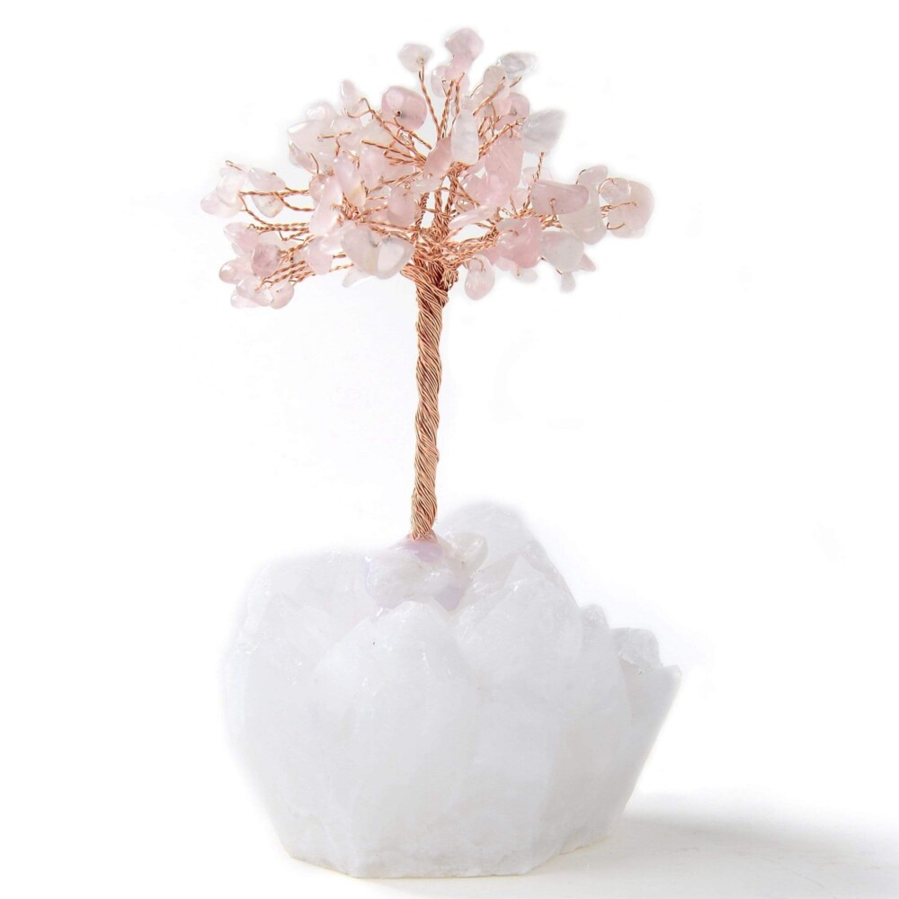 <font size="4" style="font-family: "EB Garamond";">Rose Quartz Beaded Gemstone Tree On Quartz Crystal Base</font><div style="position: initial; margin: initial; font-family: "EB Garamond";"><font size="4"><br style="position: initial; margin: initial; font-family: "EB Garamond";"></font></div><div style="position: initial; margin: initial; font-family: "EB Garamond";"><p style="margin: initial; padding: 0px; border: 0px; font-variant-numeric: inherit; font-variant-east-asian: inherit; font-stretch: inherit; line-height: inherit; font-family: "EB Garamond"; vertical-align: baseline; color: rgb(51, 51, 51); position: initial;"><font size="4">All natural semi-precious gemstones estimated at 109 pieces.</font></p><p style="margin: initial; padding: 0px; border: 0px; font-variant-numeric: inherit; font-variant-east-asian: inherit; font-stretch: inherit; line-height: inherit; font-family: "EB Garamond"; vertical-align: baseline; color: rgb(51, 51, 51); position: initial;"><font size="4">This tree features Brazilian Rose Quartz. Rose Quartz is believed to:</font></p><ul style="margin: initial; padding: 0px; border: 0px; font-variant-numeric: inherit; font-variant-east-asian: inherit; font-stretch: inherit; line-height: inherit; font-family: "EB Garamond"; vertical-align: baseline; color: rgb(51, 51, 51); position: initial;"><li style="margin: initial; padding: 0px; border: 0px; font-style: inherit; font-variant: inherit; font-weight: inherit; font-stretch: inherit; line-height: inherit; font-family: "EB Garamond"; vertical-align: baseline; list-style: outside disc; position: initial;"><font size="4">Restore trust and in relationships.</font></li><li style="margin: initial; padding: 0px; border: 0px; font-style: inherit; font-variant: inherit; font-weight: inherit; font-stretch: inherit; line-height: inherit; font-family: "EB Garamond"; vertical-align: baseline; list-style: outside disc; position: initial;"><font size="4">Encourage unconditional love.</font></li><li style="margin: initial; padding: 0px; border: 0px; font-style: inherit; font-variant: inherit; font-weight: inherit; font-stretch: inherit; line-height: inherit; font-family: "EB Garamond"; vertical-align: baseline; list-style: outside disc; position: initial;"><font size="4">Purifies and opens the heart to promote love, friendship, deep inner healing, and feelings of peace.</font></li><li style="margin: initial; padding: 0px; border: 0px; font-style: inherit; font-variant: inherit; font-weight: inherit; font-stretch: inherit; line-height: inherit; font-family: "EB Garamond"; vertical-align: baseline; list-style: outside disc; position: initial;"><font size="4">Helps you find comfort in grief.</font></li></ul><p style="margin: initial; padding: 0px; border: 0px; font-variant-numeric: inherit; font-variant-east-asian: inherit; font-stretch: inherit; line-height: inherit; font-family: "EB Garamond"; vertical-align: baseline; color: rgb(51, 51, 51); position: initial;"><font size="4">This beautiful tree rests on a natural Brazilian Quartz base. Clear Quartz is believed to:</font></p><ul style="margin: initial; padding: 0px; border: 0px; font-variant-numeric: inherit; font-variant-east-asian: inherit; font-stretch: inherit; line-height: inherit; font-family: "EB Garamond"; vertical-align: baseline; color: rgb(51, 51, 51); position: initial;"><li style="margin: initial; padding: 0px; border: 0px; font-style: inherit; font-variant: inherit; font-weight: inherit; font-stretch: inherit; line-height: inherit; font-family: "EB Garamond"; vertical-align: baseline; list-style: outside disc; position: initial;"><font size="4">Bring peace.</font></li><li style="margin: initial; padding: 0px; border: 0px; font-style: inherit; font-variant: inherit; font-weight: inherit; font-stretch: inherit; line-height: inherit; font-family: "EB Garamond"; vertical-align: baseline; list-style: outside disc; position: initial;"><font size="4">Alleviate stress and anxiety.</font></li><li style="margin: initial; padding: 0px; border: 0px; font-style: inherit; font-variant: inherit; font-weight: inherit; font-stretch: inherit; line-height: inherit; font-family: "EB Garamond"; vertical-align: baseline; list-style: outside disc; position: initial;"><font size="4">Amplify your energy and intentions.</font></li></ul><p style="margin: initial; padding: 0px; border: 0px; font-variant-numeric: inherit; font-variant-east-asian: inherit; font-stretch: inherit; line-height: inherit; font-family: "EB Garamond"; vertical-align: baseline; color: rgb(51, 51, 51); position: initial;"><font size="4">Measures at 4 inches tall.</font></p><p style="margin: initial; padding: 0px; border: 0px; font-variant-numeric: inherit; font-variant-east-asian: inherit; font-stretch: inherit; line-height: inherit; font-family: "EB Garamond"; vertical-align: baseline; color: rgb(51, 51, 51); position: initial;"><font size="4">As this is an original, hand-made gemstone tree, please allow for slight variations in the size and color of the gemstones shown.</font></p></div> Rose Quartz Beaded Gemstone Tree On Quartz Crystal Base