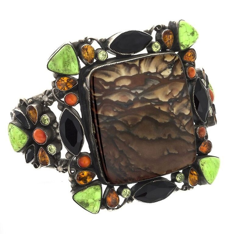 <font size="4"><span style="font-family: "EB Garamond";"><span style="font-family: "EB Garamond";"><font size="4">A truly beautiful Jasper Cuff . A large center stone of Picture Jasper is surrounded by faceted Peridot, Garnet and Citrine. Cabochons of Spiny Oyster and Lime Green Turquoise also make this Picture Jasper Cuff glisten with overwhelming beauty.</font></span></span></font> Leo Feeney Picture Jasper Cuff -Clouds With Onyx, Green Turquoise, Citrine, Peridot & Spiny Oyster