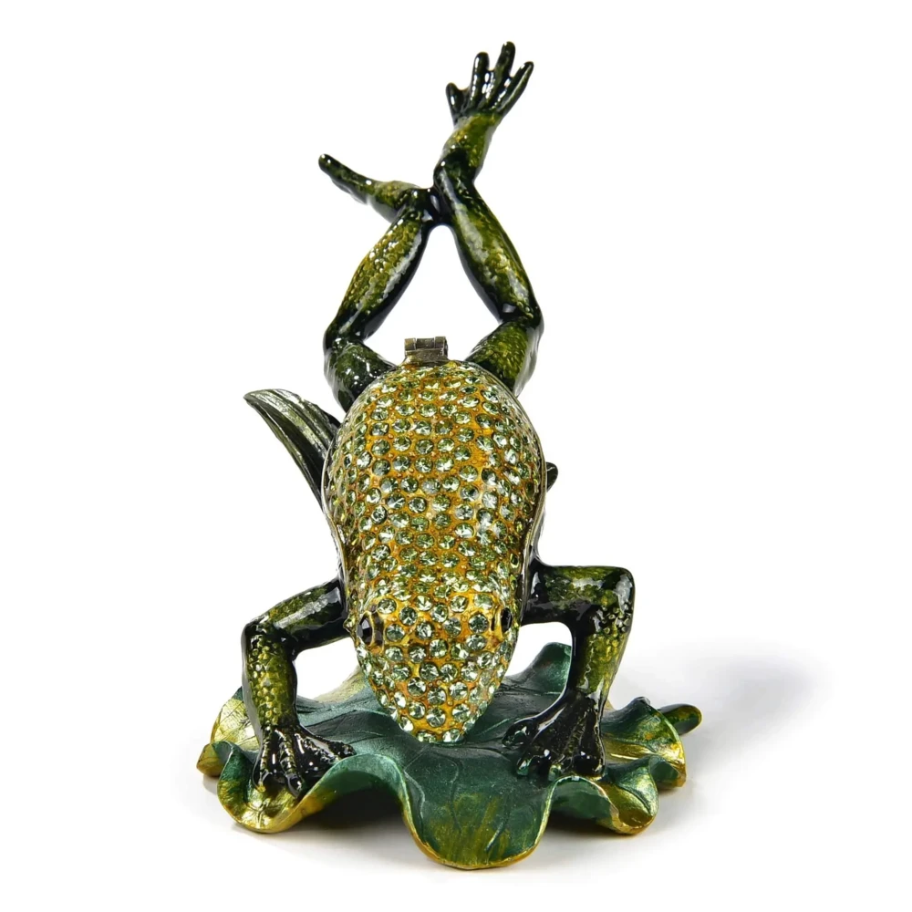 <font size="4" style="font-family: "EB Garamond";">Leaping Frog Figurine Jewel Box </font><div style="position: initial; margin: initial; font-family: "EB Garamond";"><font size="4"><br style="position: initial; margin: initial; font-family: "EB Garamond";"></font></div><div style="position: initial; margin: initial; font-family: "EB Garamond";"><p style="margin: initial; padding: 0px; border: 0px; font-family: "EB Garamond"; font-stretch: inherit; line-height: inherit; vertical-align: baseline; caret-color: rgb(51, 51, 51); color: rgb(51, 51, 51); text-size-adjust: auto; position: initial;"><font size="4">Enjoy this original, jeweled figurine box made with sparkling crystals.<br style="position: initial; margin: initial; font-family: "EB Garamond";"><br style="position: initial; margin: initial; font-family: "EB Garamond";">This trinket box is glazed with pearlized enamel and is perfect for displaying on your desk, vanity, bedroom, and office. The hand-set crystals bring out a special sparkle to wherever it is displayed.</font></p><p style="margin: initial; padding: 0px; border: 0px; font-family: "EB Garamond"; font-stretch: inherit; line-height: inherit; vertical-align: baseline; caret-color: rgb(51, 51, 51); color: rgb(51, 51, 51); text-size-adjust: auto; position: initial;"><font size="4"><br style="position: initial; margin: initial; font-family: "EB Garamond";">You will find a hidden hinge that opens up a secret compartment for your treasured jewelry, stones, and prized possessions.<br style="position: initial; margin: initial; font-family: "EB Garamond";"><br></font></p><p style="margin: initial; padding: 0px; border: 0px; font-family: "EB Garamond"; font-stretch: inherit; line-height: inherit; vertical-align: baseline; caret-color: rgb(51, 51, 51); color: rgb(51, 51, 51); text-size-adjust: auto; position: initial;"><font size="4">Height: 2.75 in.</font></p><p style="margin: initial; padding: 0px; border: 0px; font-family: "EB Garamond"; font-stretch: inherit; line-height: inherit; vertical-align: baseline; caret-color: rgb(51, 51, 51); color: rgb(51, 51, 51); text-size-adjust: auto; position: initial;"><font size="4">Length: 4.5 in.</font></p><p style="margin: initial; padding: 0px; border: 0px; font-family: "EB Garamond"; font-stretch: inherit; line-height: inherit; vertical-align: baseline; caret-color: rgb(51, 51, 51); color: rgb(51, 51, 51); text-size-adjust: auto; position: initial;"><font size="4">Width: 2.5 in.</font></p><p style="margin: initial; padding: 0px; border: 0px; font-family: "EB Garamond"; font-stretch: inherit; line-height: inherit; vertical-align: baseline; caret-color: rgb(51, 51, 51); color: rgb(51, 51, 51); text-size-adjust: auto; position: initial;"><font size="4">Weight: 162 grams.</font></p></div> Leaping Frog Figurine Jewel Box
