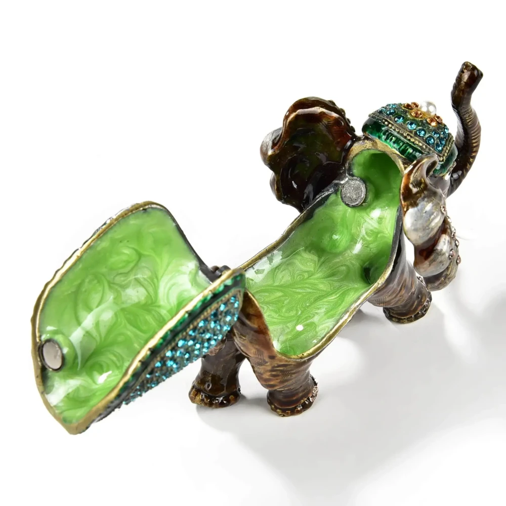 <font size="4"><span style="font-family: "EB Garamond";">Aqua Elephant Figurine Jewel Box</span></font><div style="position: initial; margin: initial; font-family: "EB Garamond";"><font size="4"><br style="position: initial; margin: initial; font-family: "EB Garamond";"></font></div><div style="position: initial; margin: initial; font-family: "EB Garamond";"><p style="margin: initial; padding: 0px; border: 0px; font-family: "EB Garamond"; font-stretch: inherit; line-height: inherit; vertical-align: baseline; caret-color: rgb(51, 51, 51); color: rgb(51, 51, 51); text-size-adjust: auto; position: initial;"><font size="4">Enjoy this original, jeweled figurine box made with sparkling crystals.<br style="position: initial; margin: initial; font-family: "EB Garamond";"><br style="position: initial; margin: initial; font-family: "EB Garamond";">This trinket box is glazed with pearlized enamel and is perfect for displaying on your desk, vanity, bedroom, and office. The hand-set crystals bring out a special sparkle to wherever it is displayed.</font></p><p style="margin: initial; padding: 0px; border: 0px; font-family: "EB Garamond"; font-stretch: inherit; line-height: inherit; vertical-align: baseline; caret-color: rgb(51, 51, 51); color: rgb(51, 51, 51); text-size-adjust: auto; position: initial;"><font size="4"><br style="position: initial; margin: initial; font-family: "EB Garamond";">You will find a hidden hinge that opens up a secret compartment for your treasured jewelry, stones, and prized possessions.<br style="position: initial; margin: initial; font-family: "EB Garamond";"><br></font></p><p style="margin: initial; padding: 0px; border: 0px; font-family: "EB Garamond"; font-stretch: inherit; line-height: inherit; vertical-align: baseline; caret-color: rgb(51, 51, 51); color: rgb(51, 51, 51); text-size-adjust: auto; position: initial;"><font size="4">Height: 2.75 in.</font></p><p style="margin: initial; padding: 0px; border: 0px; font-family: "EB Garamond"; font-stretch: inherit; line-height: inherit; vertical-align: baseline; caret-color: rgb(51, 51, 51); color: rgb(51, 51, 51); text-size-adjust: auto; position: initial;"><font size="4">Length: 3.5 in.</font></p><p style="margin: initial; padding: 0px; border: 0px; font-family: "EB Garamond"; font-stretch: inherit; line-height: inherit; vertical-align: baseline; caret-color: rgb(51, 51, 51); color: rgb(51, 51, 51); text-size-adjust: auto; position: initial;"><font size="4">Width: 2.25 in.</font></p><p style="margin: initial; padding: 0px; border: 0px; font-family: "EB Garamond"; font-stretch: inherit; line-height: inherit; vertical-align: baseline; caret-color: rgb(51, 51, 51); color: rgb(51, 51, 51); text-size-adjust: auto; position: initial;"><font size="4">Weight: 250.3 grams.</font></p></div> Aqua Elephant Figurine Jewel Box