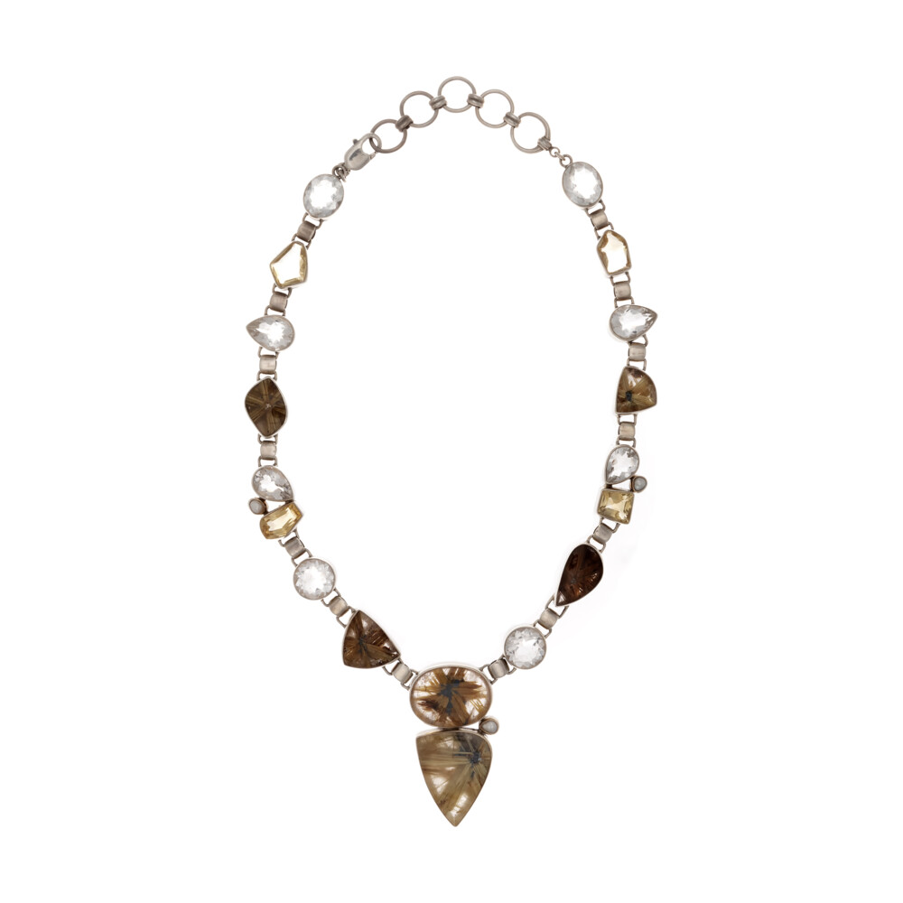 <font size="4"><span style="font-family: "EB Garamond";"><font size="4">Golden Rutile Quartz Necklace With Quartz & Pearl</font></span></font><div style="position: initial; margin: initial; font-family: "EB Garamond";"><font size="4"><br style="position: initial; margin: initial; font-family: "EB Garamond";"></font></div><div style="position: initial; margin: initial; font-family: "EB Garamond";"><p style="margin: initial; font-variant-numeric: normal; font-variant-east-asian: normal; font-stretch: normal; line-height: normal; font-family: "EB Garamond"; color: rgb(0, 0, 0); position: initial;"><font size="4">The Golden </font><b style="font-size: 0.875em; position: initial; margin: initial;"><font size="4">Rutile Quartz</font></b></p><p style="margin: initial; font-variant-numeric: normal; font-variant-east-asian: normal; font-stretch: normal; line-height: normal; font-family: "EB Garamond"; color: rgb(0, 0, 0); position: initial;"><font size="4">aka. Venus-hair stone, rutile quartz is a</font></p><p style="margin: initial; font-variant-numeric: normal; font-variant-east-asian: normal; font-stretch: normal; line-height: normal; font-family: "EB Garamond"; color: rgb(0, 0, 0); position: initial;"><font size="4">crystalline form of silica with inclusions of the mineral ‘rutile’, which</font></p><p style="margin: initial; font-variant-numeric: normal; font-variant-east-asian: normal; font-stretch: normal; line-height: normal; font-family: "EB Garamond"; color: rgb(0, 0, 0); position: initial;"><font size="4">forms as clusters of needles. Minerals may vary from titanium to</font></p><p style="margin: initial; font-variant-numeric: normal; font-variant-east-asian: normal; font-stretch: normal; line-height: normal; font-family: "EB Garamond"; color: rgb(0, 0, 0); position: initial;"><font size="4">tourmaline. If these two minerals are forming at the same time, the</font></p><p style="margin: initial; font-variant-numeric: normal; font-variant-east-asian: normal; font-stretch: normal; line-height: normal; font-family: "EB Garamond"; color: rgb(0, 0, 0); position: initial;"><font size="4">titanium or mineral needles will get trapped inside the transparent</font></p><p style="margin: initial; font-variant-numeric: normal; font-variant-east-asian: normal; font-stretch: normal; line-height: normal; font-family: "EB Garamond"; color: rgb(0, 0, 0); position: initial;"><font size="4">quartz. This produces the hair-like gold and silver color threads that</font></p><p style="margin: initial; font-variant-numeric: normal; font-variant-east-asian: normal; font-stretch: normal; line-height: normal; font-family: "EB Garamond"; color: rgb(0, 0, 0); position: initial;"><font size="4">reflect light inside of the quartz. Excellent in assisting in the decision</font></p><p style="margin: initial; font-variant-numeric: normal; font-variant-east-asian: normal; font-stretch: normal; line-height: normal; font-family: "EB Garamond"; color: rgb(0, 0, 0); position: initial;"><font size="4">making process, it is very helpful in uncovering the causes of mental</font></p><p style="font-variant-numeric: normal; font-variant-east-asian: normal; font-stretch: normal; line-height: normal; font-family: "EB Garamond"; color: rgb(0, 0, 0); position: initial; margin: initial;"><font size="4">issues and hang-ups.</font></p></div> Golden Rutile Quartz Necklace With Quartz & Pearl