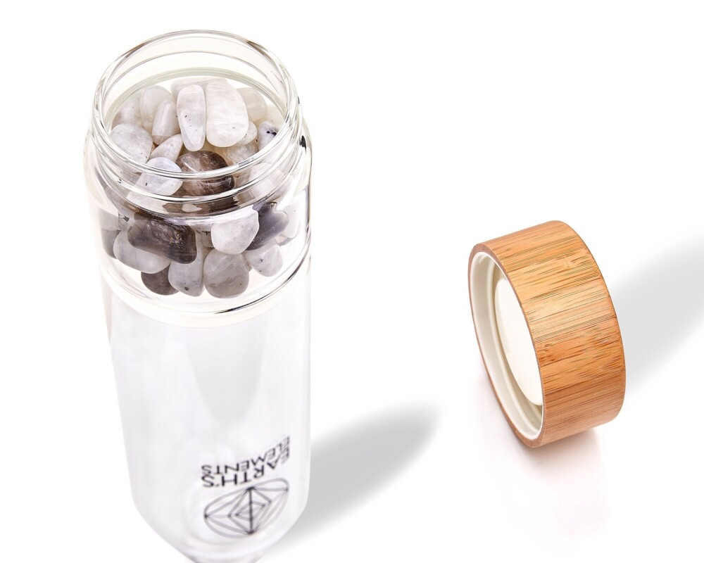 <font size="4"><span style="font-family: "EB Garamond";"><font size="4">Divine Empowerment Crystal Water Bottle</font></span></font><div style="position: initial; margin: initial; font-family: "EB Garamond";"><p style="margin: initial; font-variant-numeric: normal; font-variant-east-asian: normal; font-stretch: normal; line-height: normal; font-family: "EB Garamond"; color: rgb(0, 0, 0); position: initial;"><font size="4"><br style="font-family: "EB Garamond";"></font></p><p style="margin: initial; font-variant-numeric: normal; font-variant-east-asian: normal; font-stretch: normal; line-height: normal; font-family: "EB Garamond"; color: rgb(0, 0, 0); position: initial;"><font size="4">This bottle includes tumbled Moonstone and Smoky Quartz balancing your body through clearing and protective energies. Yin and Yang duality serves you through divine empowerment. </font></p><p style="margin: initial; font-variant-numeric: normal; font-variant-east-asian: normal; font-stretch: normal; line-height: normal; font-family: "EB Garamond"; color: rgb(0, 0, 0); position: initial;"><font size="4">With this beautiful and stylish gem glass bottle, you can help save the Earth.</font></p><p style="margin: initial; font-variant-numeric: normal; font-variant-east-asian: normal; font-stretch: normal; line-height: normal; font-family: "EB Garamond"; color: rgb(0, 0, 0); position: initial;"><font size="4">Plastic bottles are a health hazard and bad for the environment. We only utilize non-toxic materials with eco-friendly composition and exceptional craftsmanship.</font></p><p style="margin: initial; font-variant-numeric: normal; font-variant-east-asian: normal; font-stretch: normal; line-height: normal; font-family: "EB Garamond"; color: rgb(0, 0, 0); position: initial;"><font size="4">This bottle is the perfect reminder to drink your charged water daily! You can store any beverage without worrying about it changing in taste.</font></p><p style="margin: initial; font-variant-numeric: normal; font-variant-east-asian: normal; font-stretch: normal; line-height: normal; font-family: "EB Garamond"; color: rgb(0, 0, 0); position: initial;"><font size="4">This bottle is designed to raise your vibe and make you feel good.</font></p><p style="margin: initial; font-variant-numeric: normal; font-variant-east-asian: normal; font-stretch: normal; line-height: normal; font-family: "EB Garamond"; color: rgb(0, 0, 0); position: initial;"><font size="4">Our goal is to support your spiritual journey and to help connect one another through the gifts of our beautiful Earth.</font></p><p style="margin: initial; font-variant-numeric: normal; font-variant-east-asian: normal; font-stretch: normal; line-height: normal; font-family: "EB Garamond"; color: rgb(0, 0, 0); position: initial;"><font size="4">We feature a non-toxic airtight bamboo cup that will never leak.</font></p><p style="margin: initial; font-variant-numeric: normal; font-variant-east-asian: normal; font-stretch: normal; line-height: normal; font-family: "EB Garamond"; color: rgb(0, 0, 0); position: initial;"><font size="4">Of course, you need to be careful with your crystal bottle. Please do not force your crystals too tight because bottle divider can break. Handle with love and care.</font></p><p style="font-variant-numeric: normal; font-variant-east-asian: normal; font-stretch: normal; line-height: normal; font-family: "EB Garamond"; color: rgb(0, 0, 0); position: initial; margin: initial;"><font size="4">Your first set of crystals is included.</font></p></div> Divine Empowerment Crystal Water Bottle